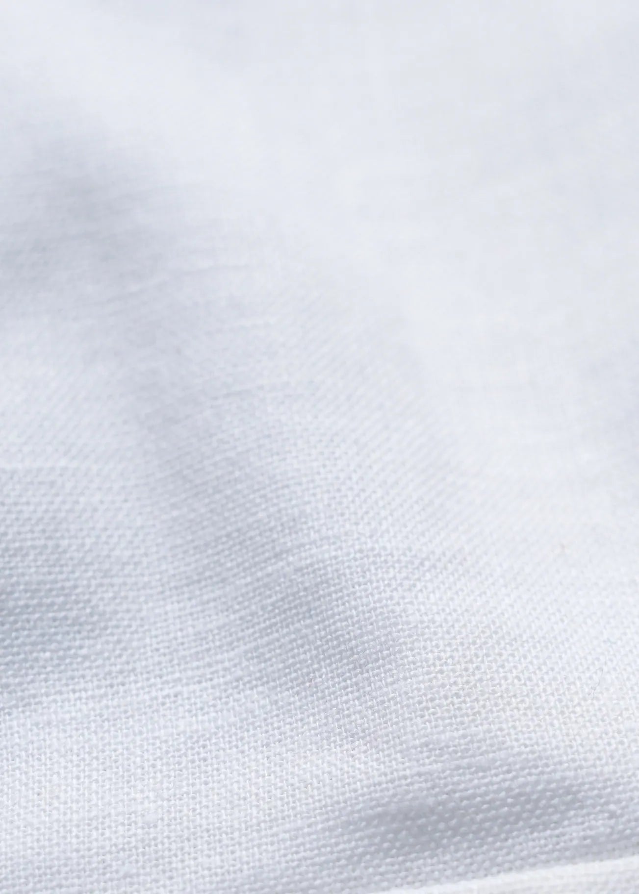 White linen fabric close-up with fine textured weave