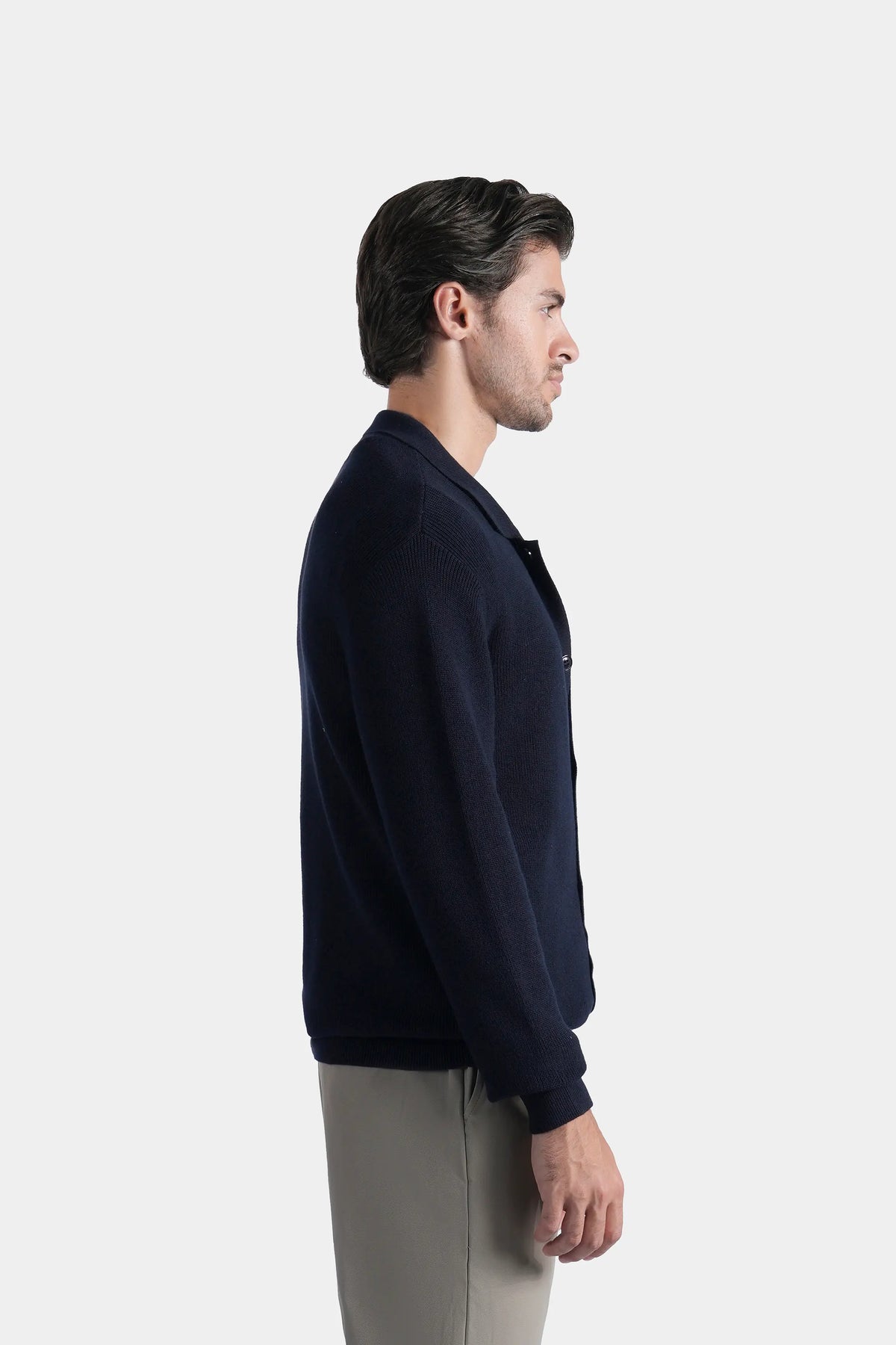 Navy knitted cardigan, long sleeves, button-front closure, side profile