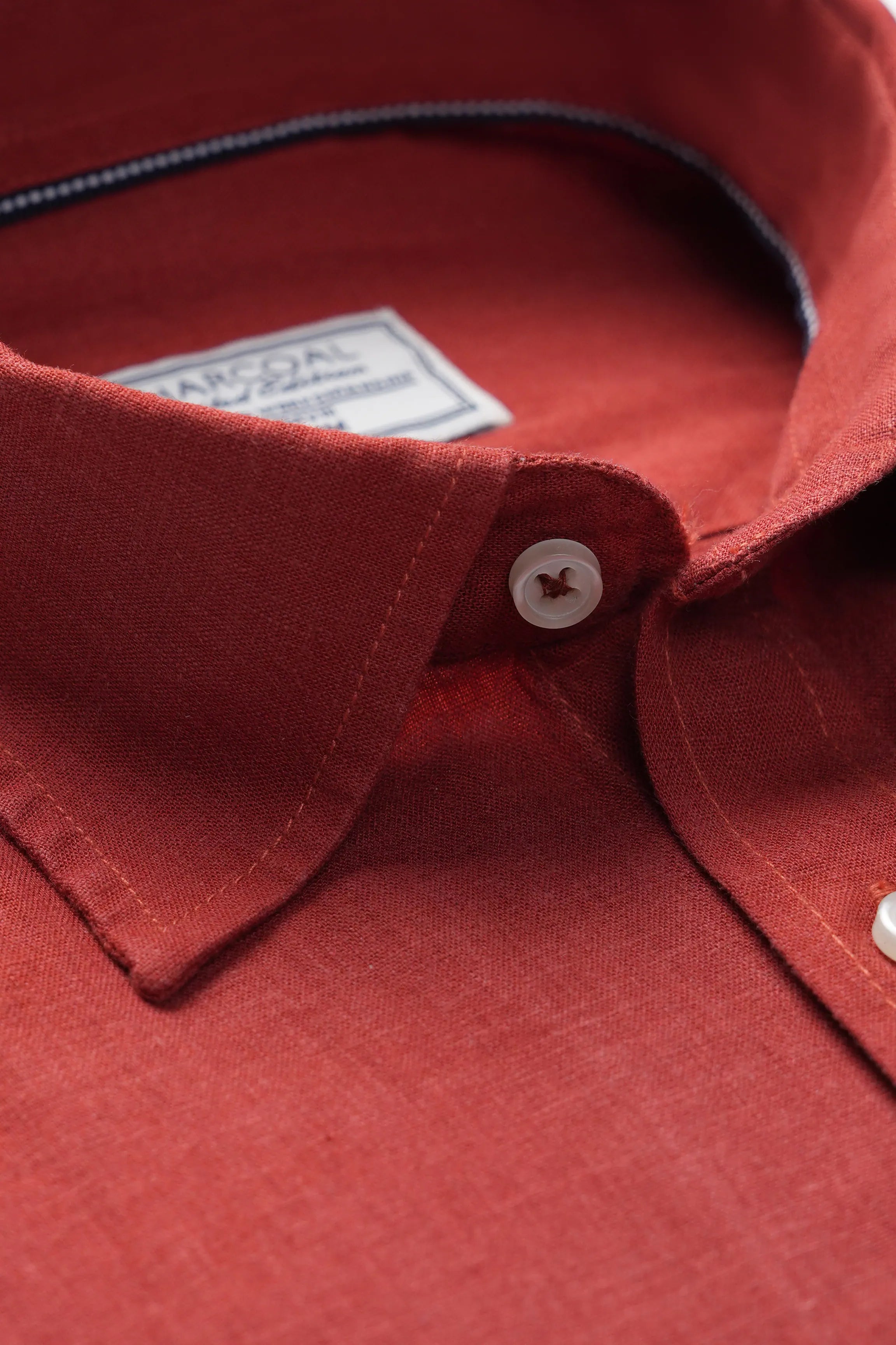 Tangerine linen shirt collar with contrast-stitched placket and white buttons