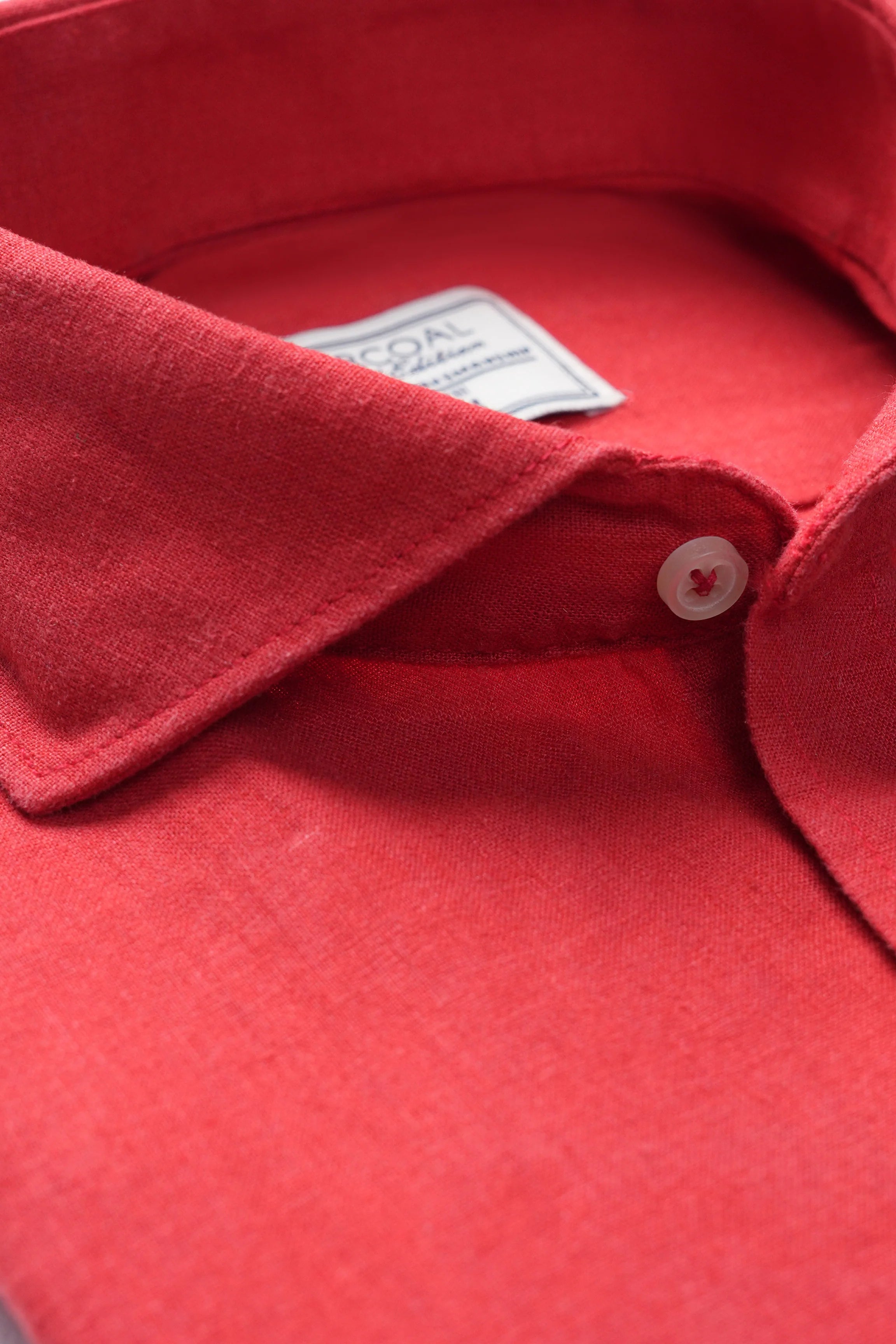Tangerine linen shirt collar and button placket close-up