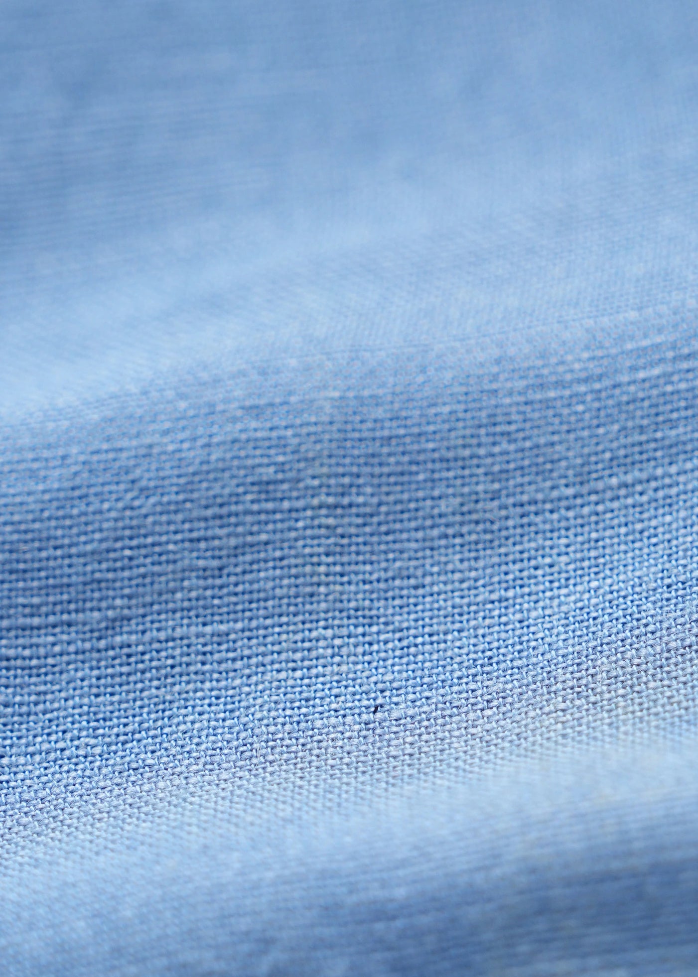 Greyish blue linen shirt fabric texture close-up, fine woven pattern