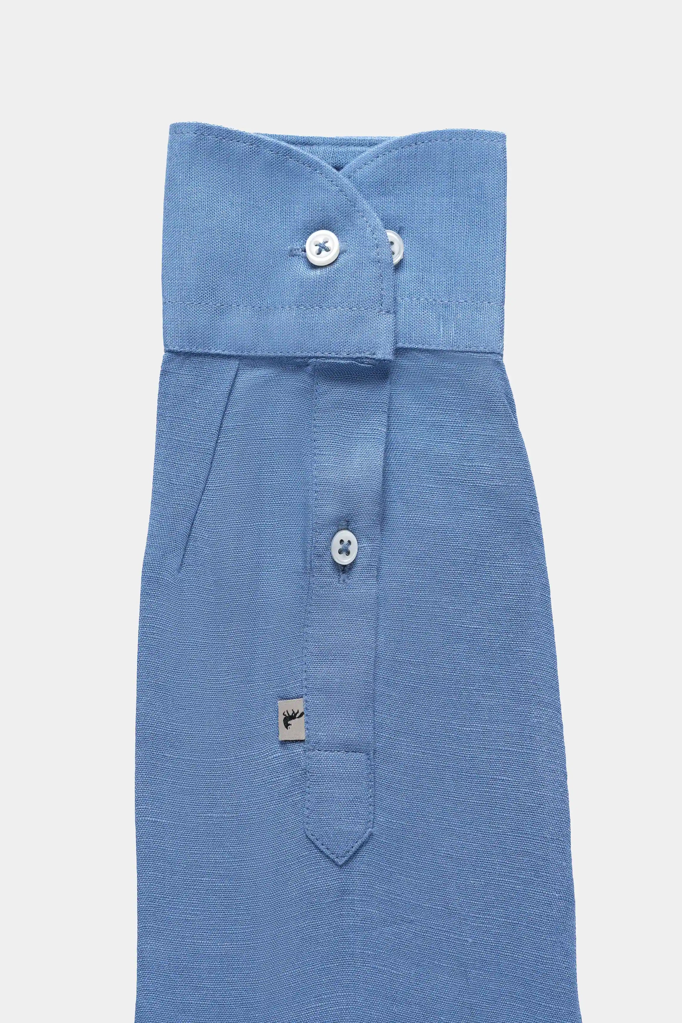 Greyish blue linen shirt front detail with folded collar tab and button placket