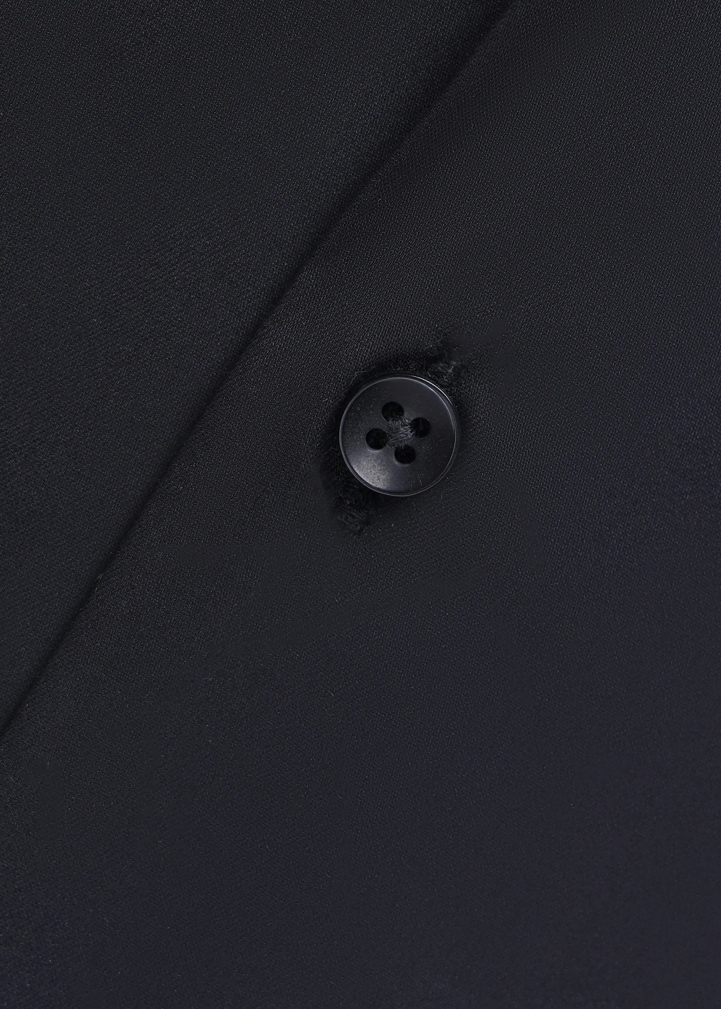 Black dress shirt fabric texture with round dark button detail