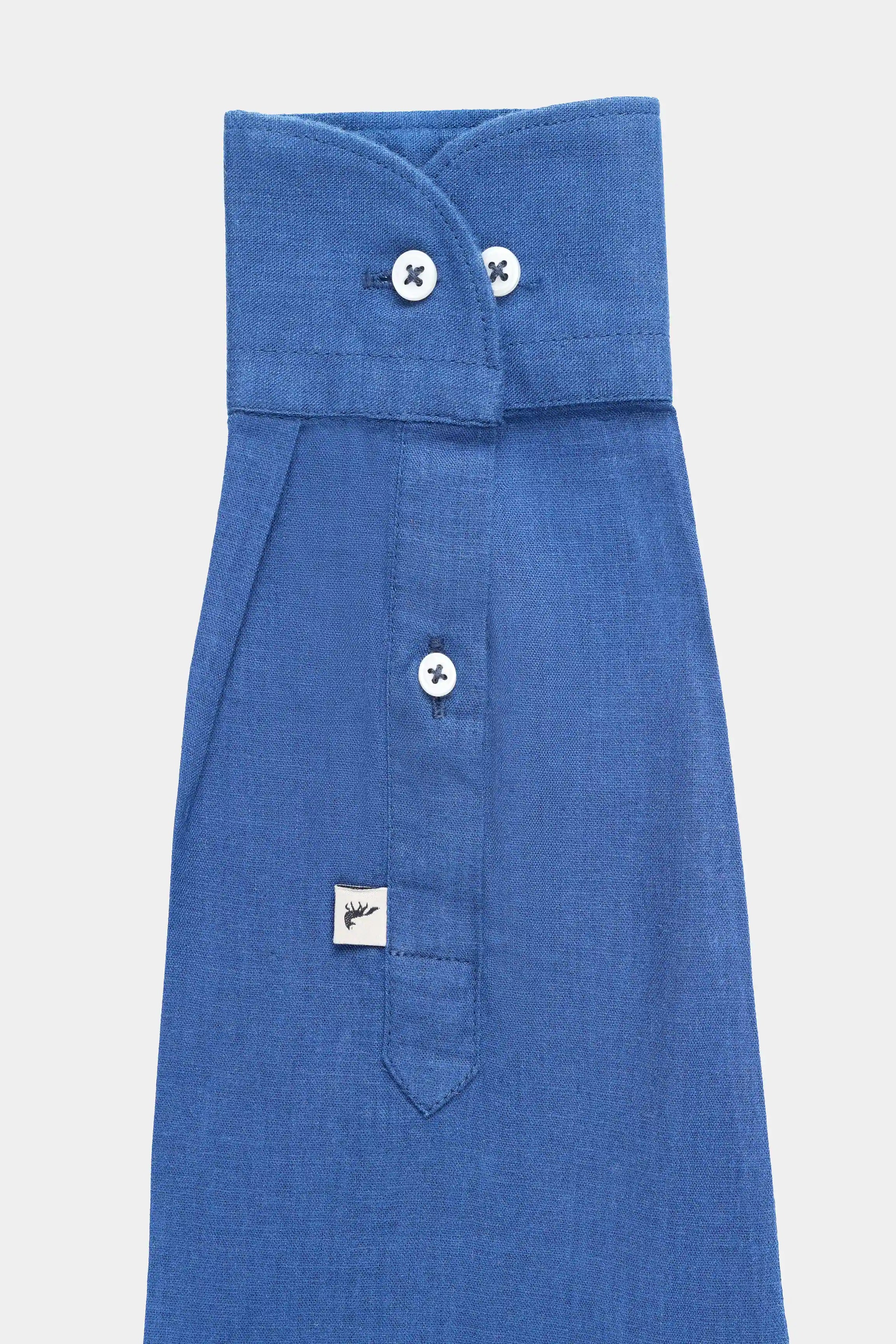 Navy linen shirt with folded collar, two top buttons, and chest pocket