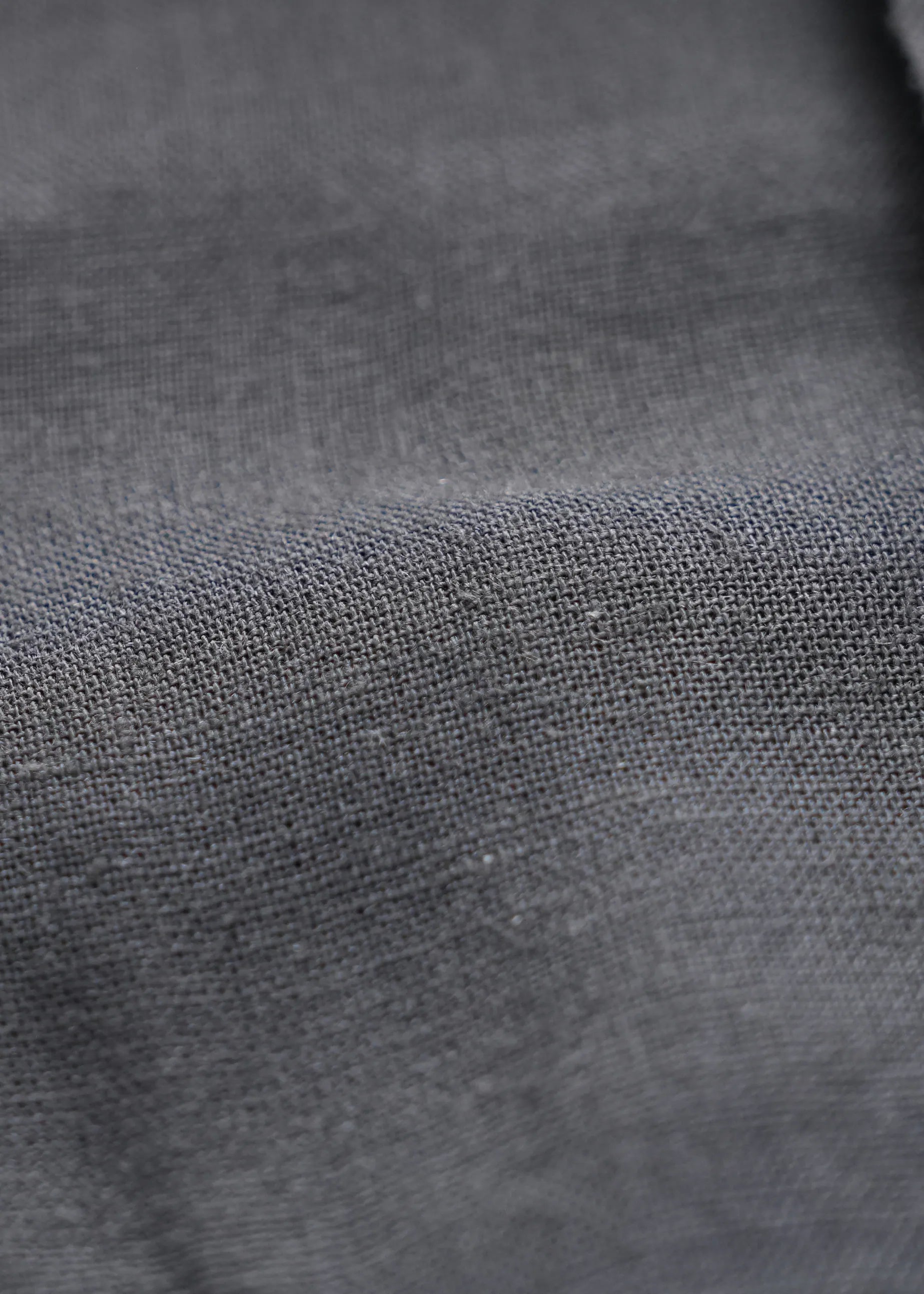 Black linen shirt fabric close-up with visible woven texture