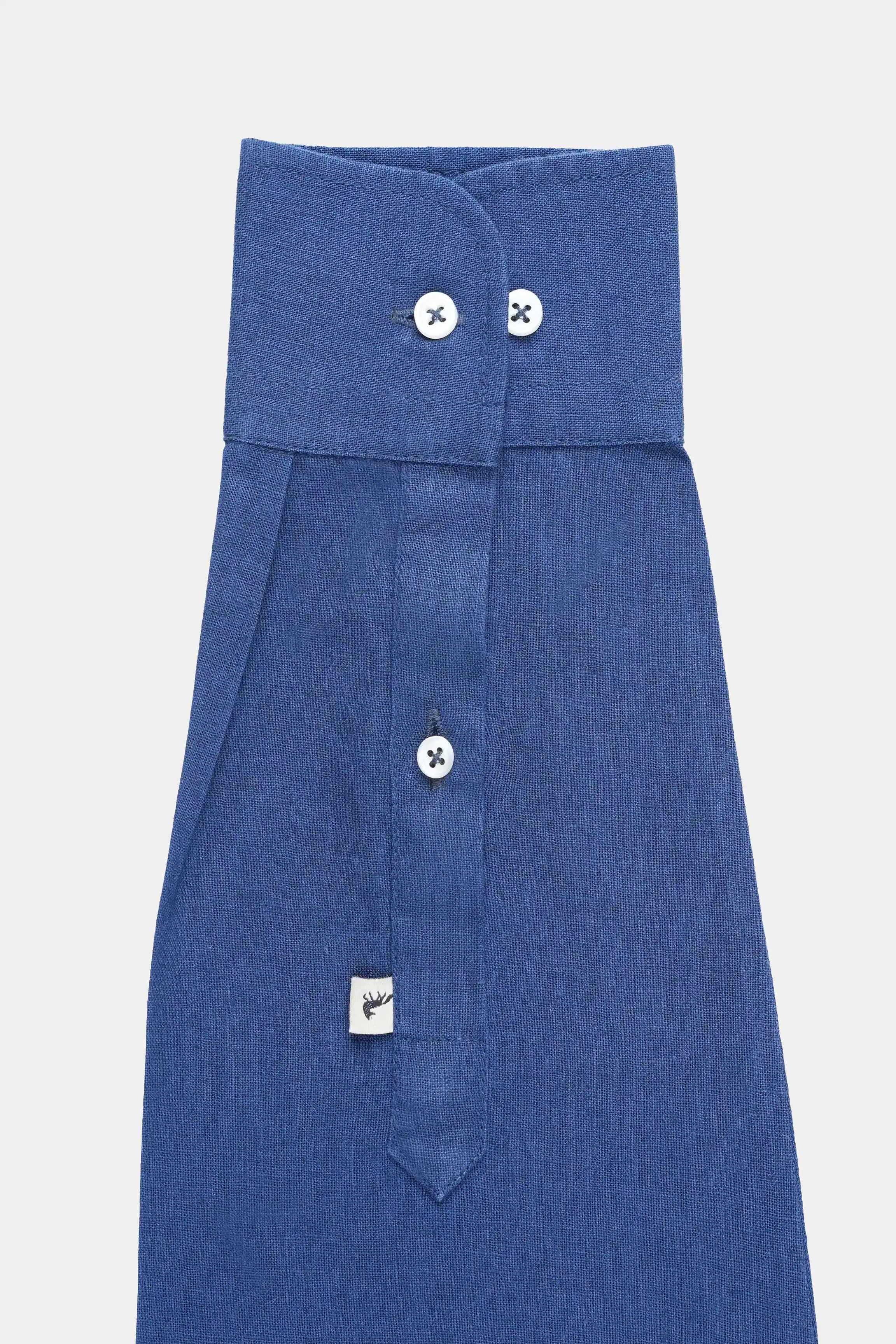 Navy linen button-up shirt folded view with buttons and hanging tag