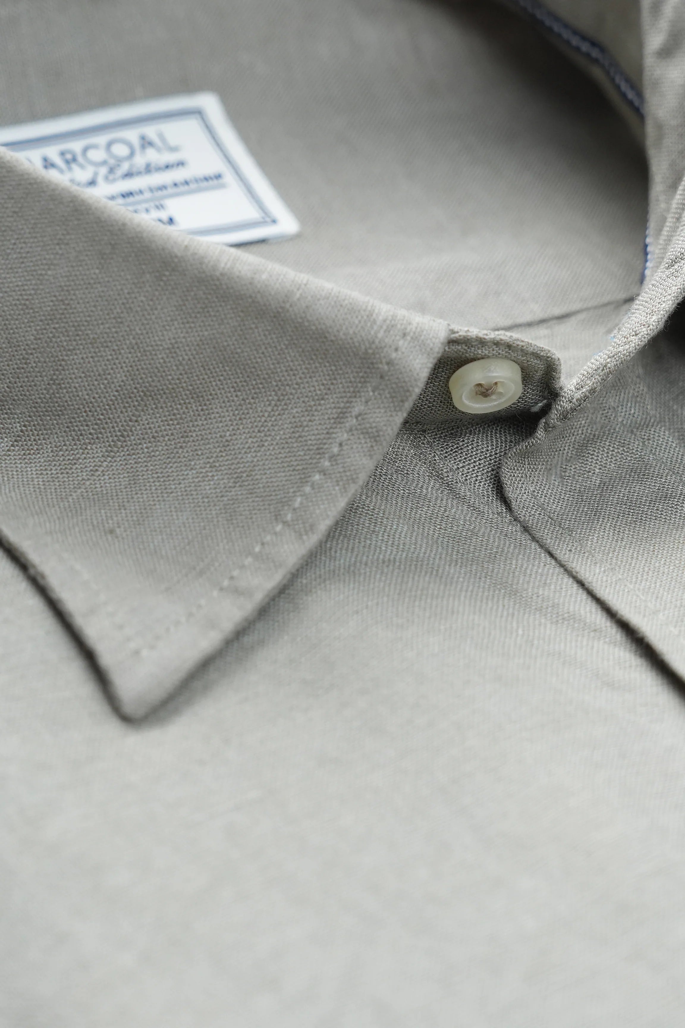 Light olive linen shirt collar with button placket and white buttons