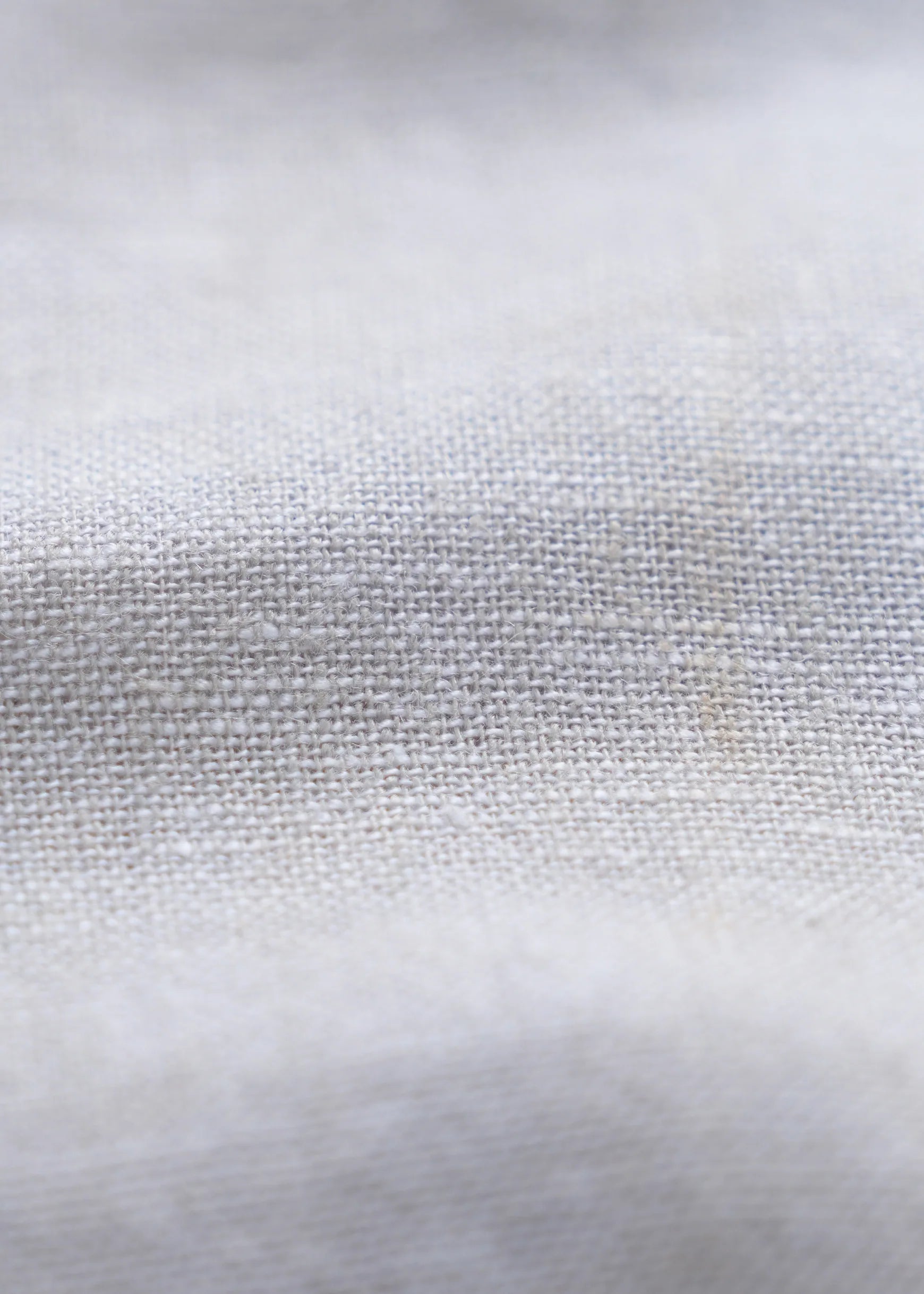 Woven linen fabric texture close-up with fine slub weave