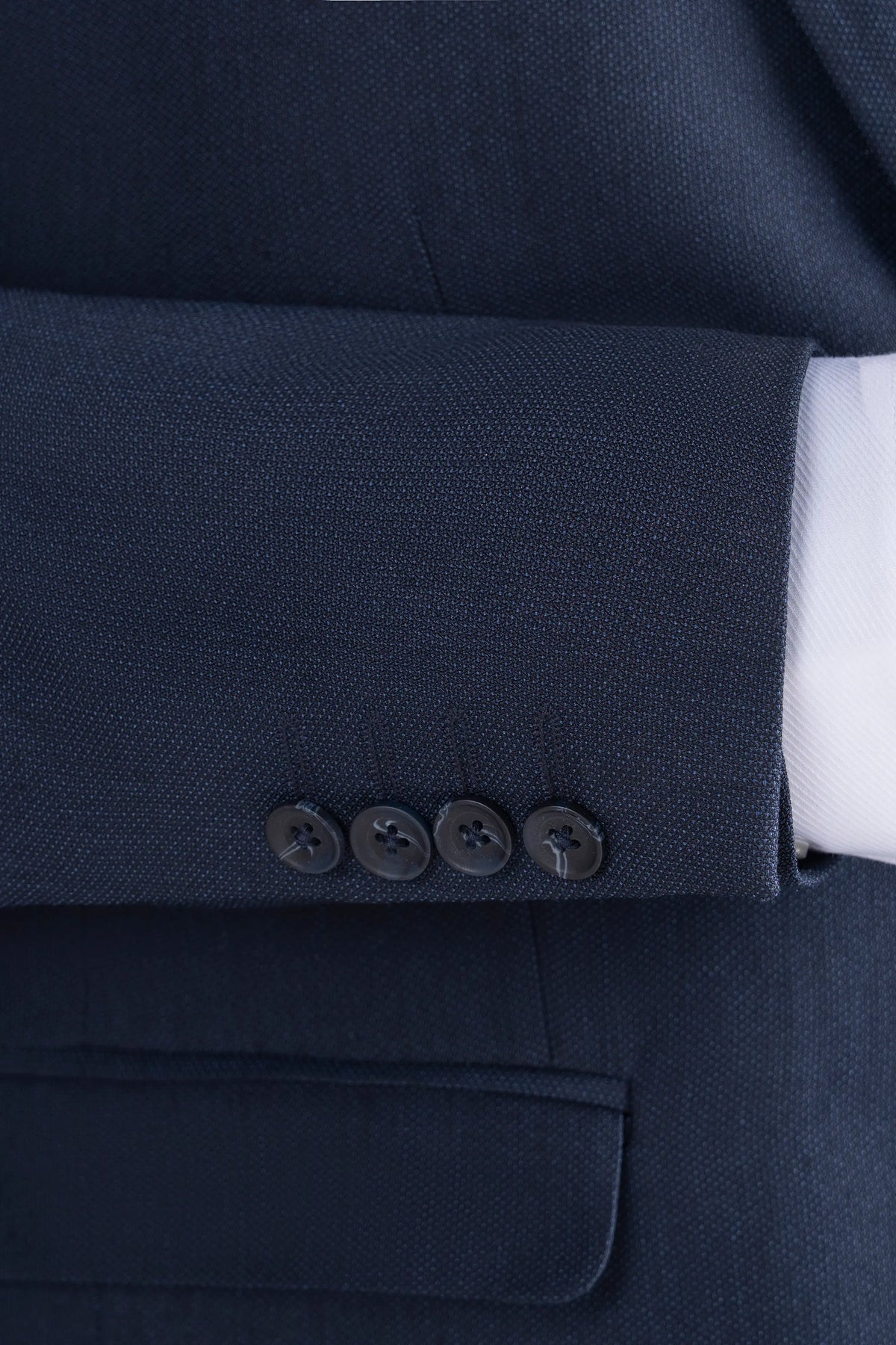 Navy suit blazer sleeve cuff with buttons and flap pocket detail