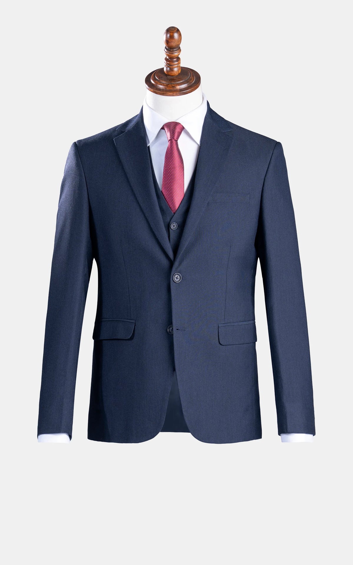 Dark navy slim-fit suit jacket and matching vest with red necktie and white shirt