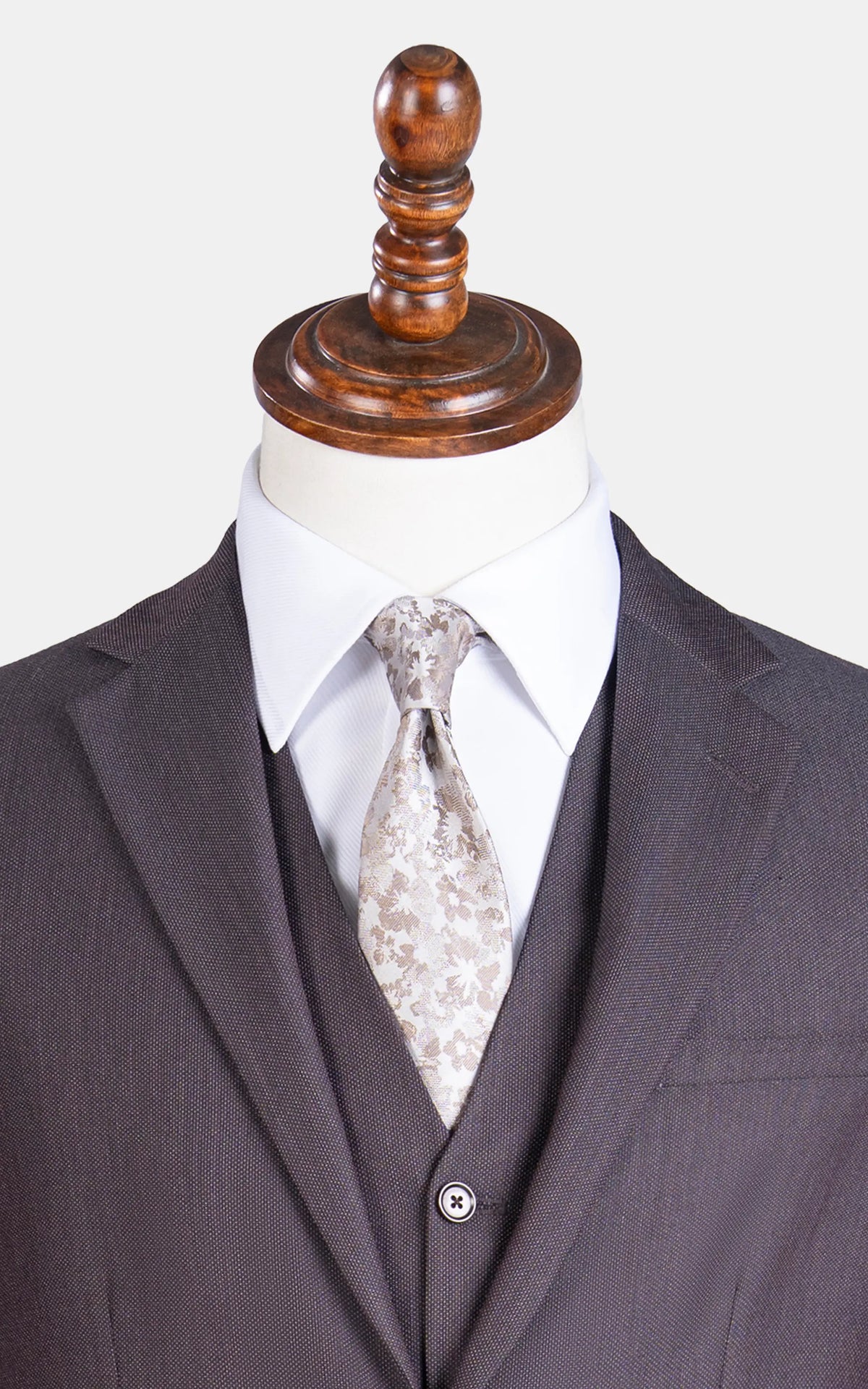 Dark brown suit jacket and vest with notch lapel and patterned necktie