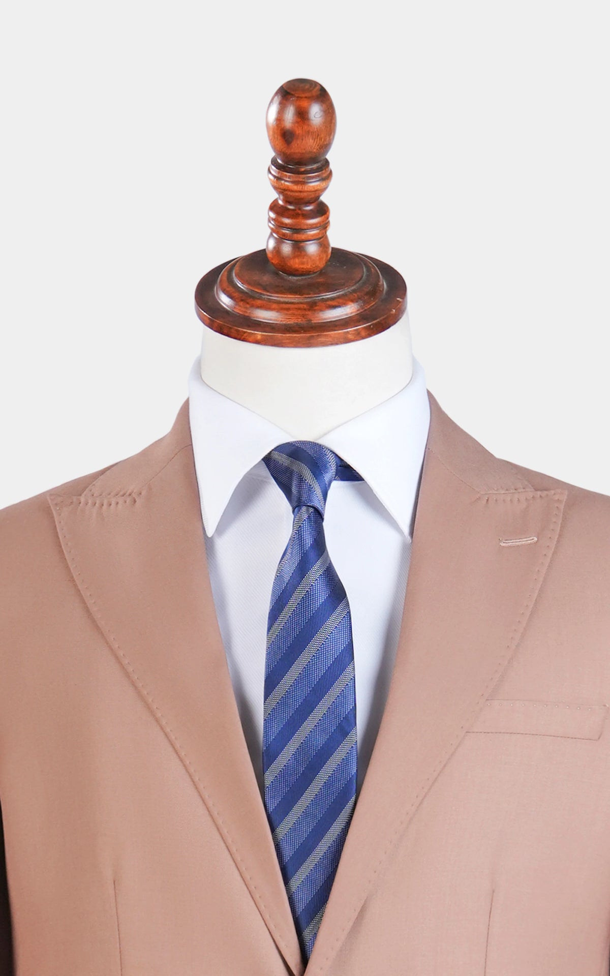 Close-up of light brown suit jacket lapels over blue striped necktie.