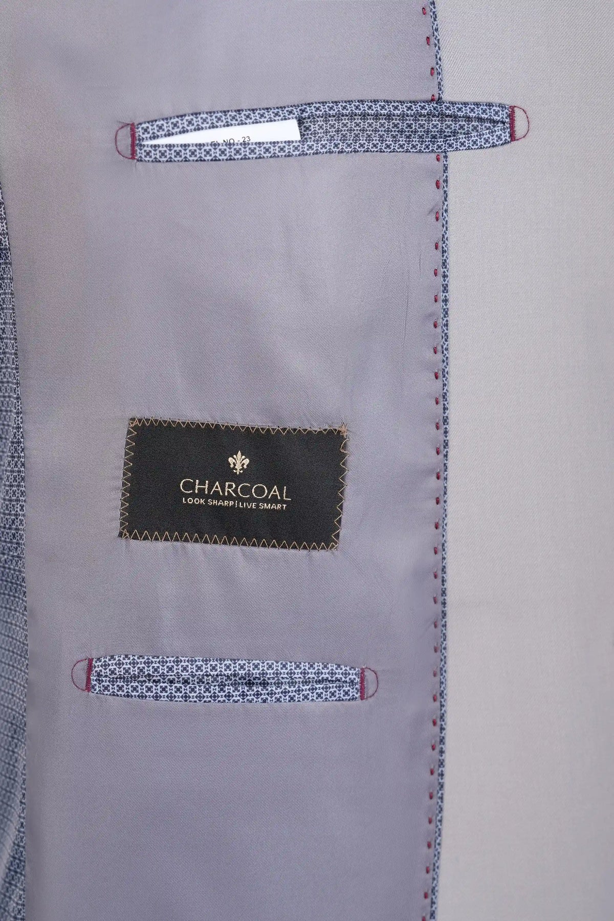 Stone gray suit jacket interior with charcoal label and stitched trim