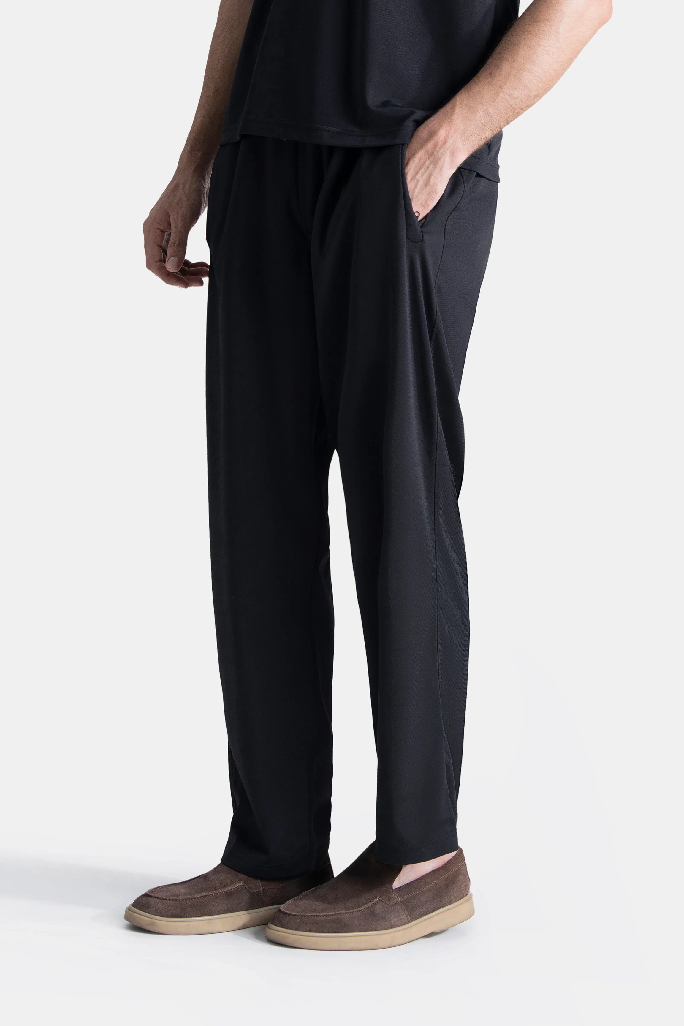 Black relaxed trousers with elastic waist, side pocket detail, and straight legs