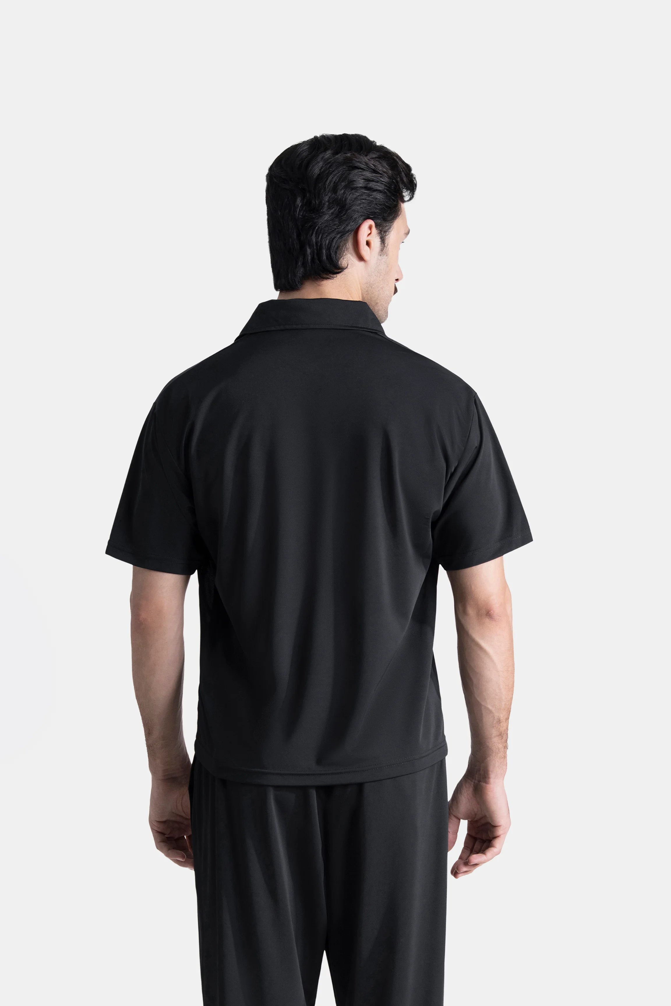 Black polo shirt back view with short sleeves and loose drape