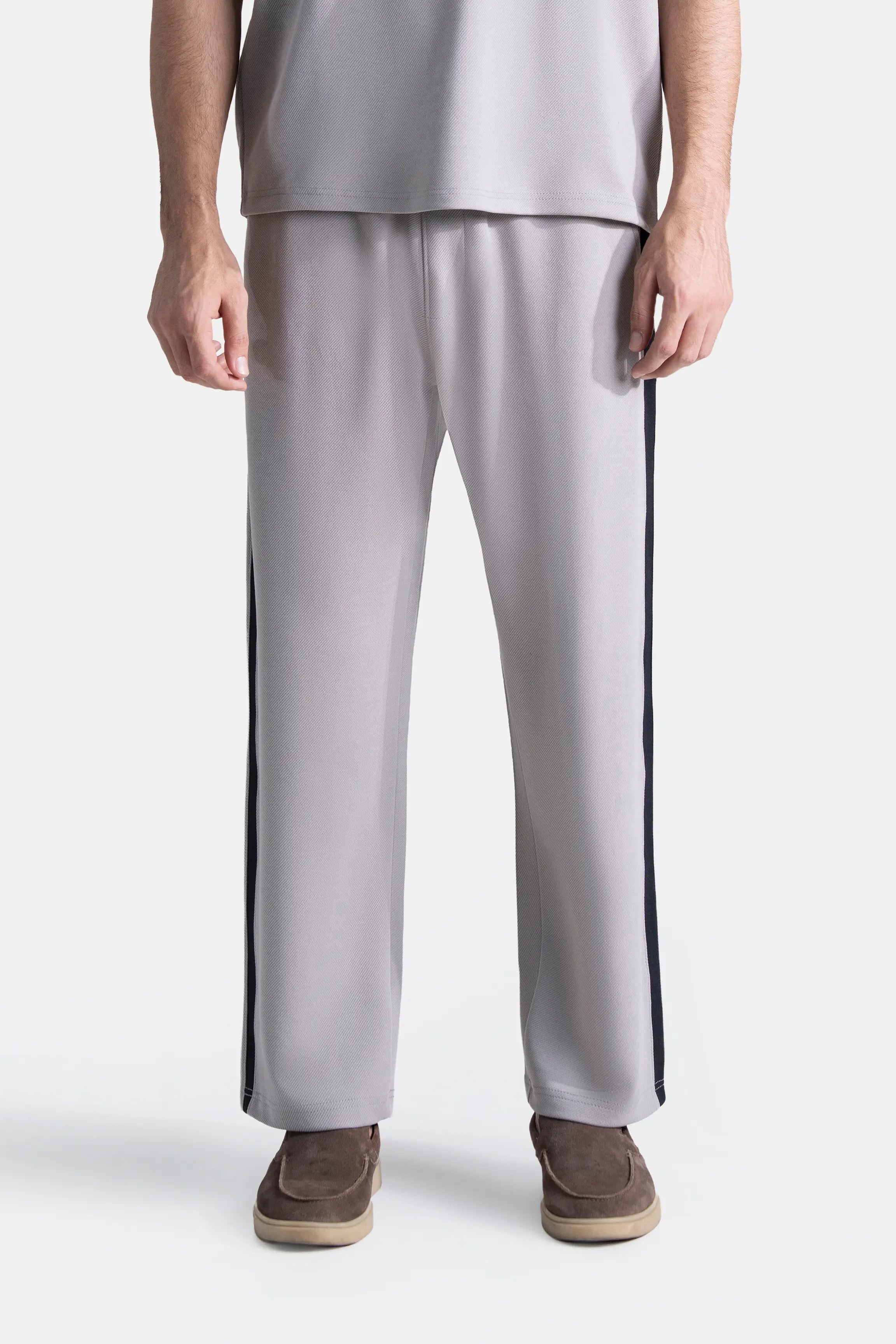 Grey loose-fit trousers with navy side stripe, straight leg, cropped ankle length