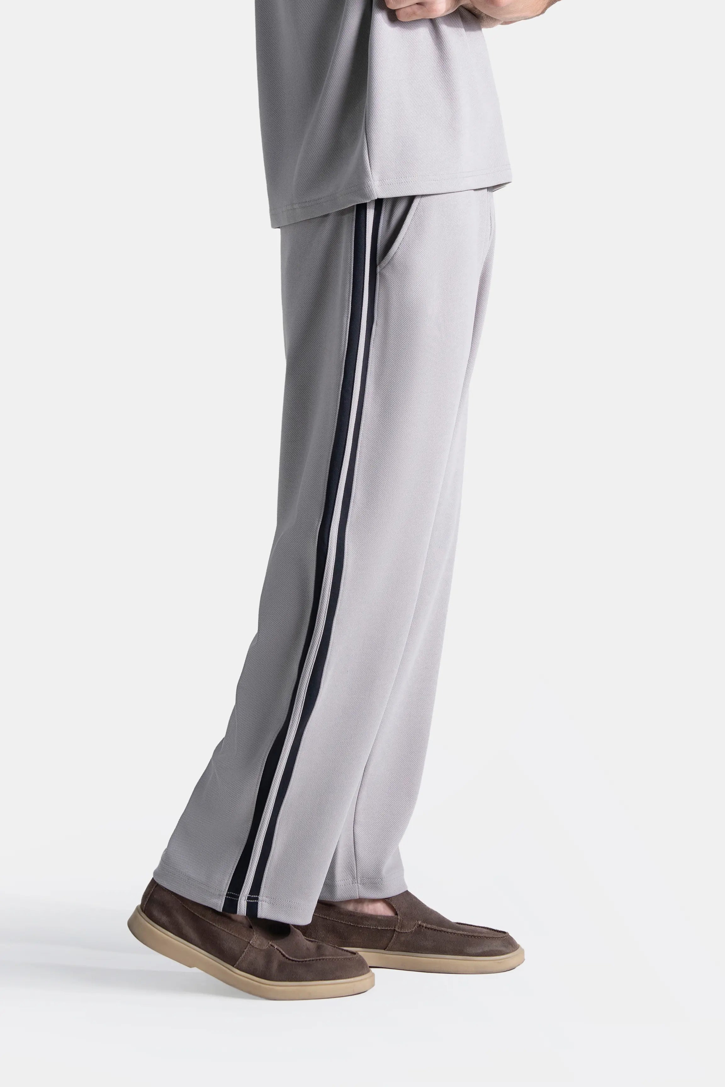 Grey loose-fit trousers with navy side stripe and wide straight leg