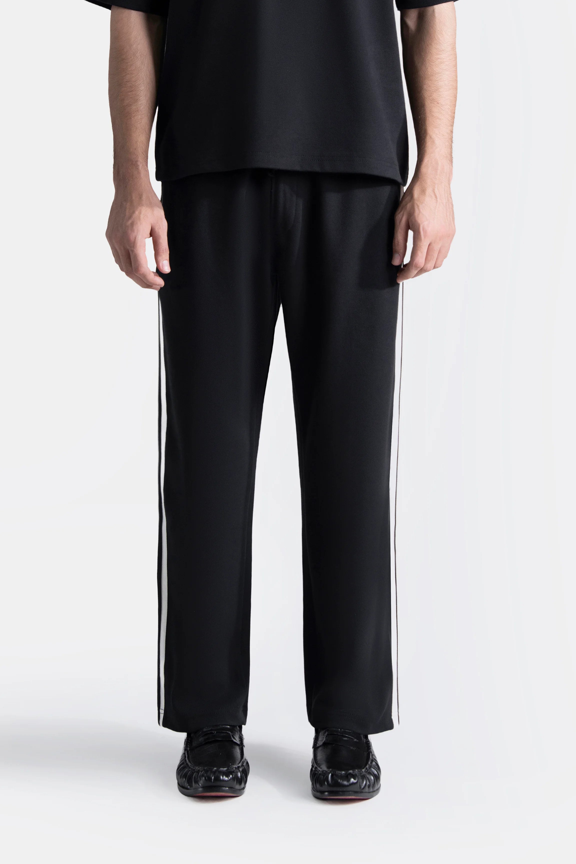 Black loose-fit trousers with straight leg and drawstring waistband
