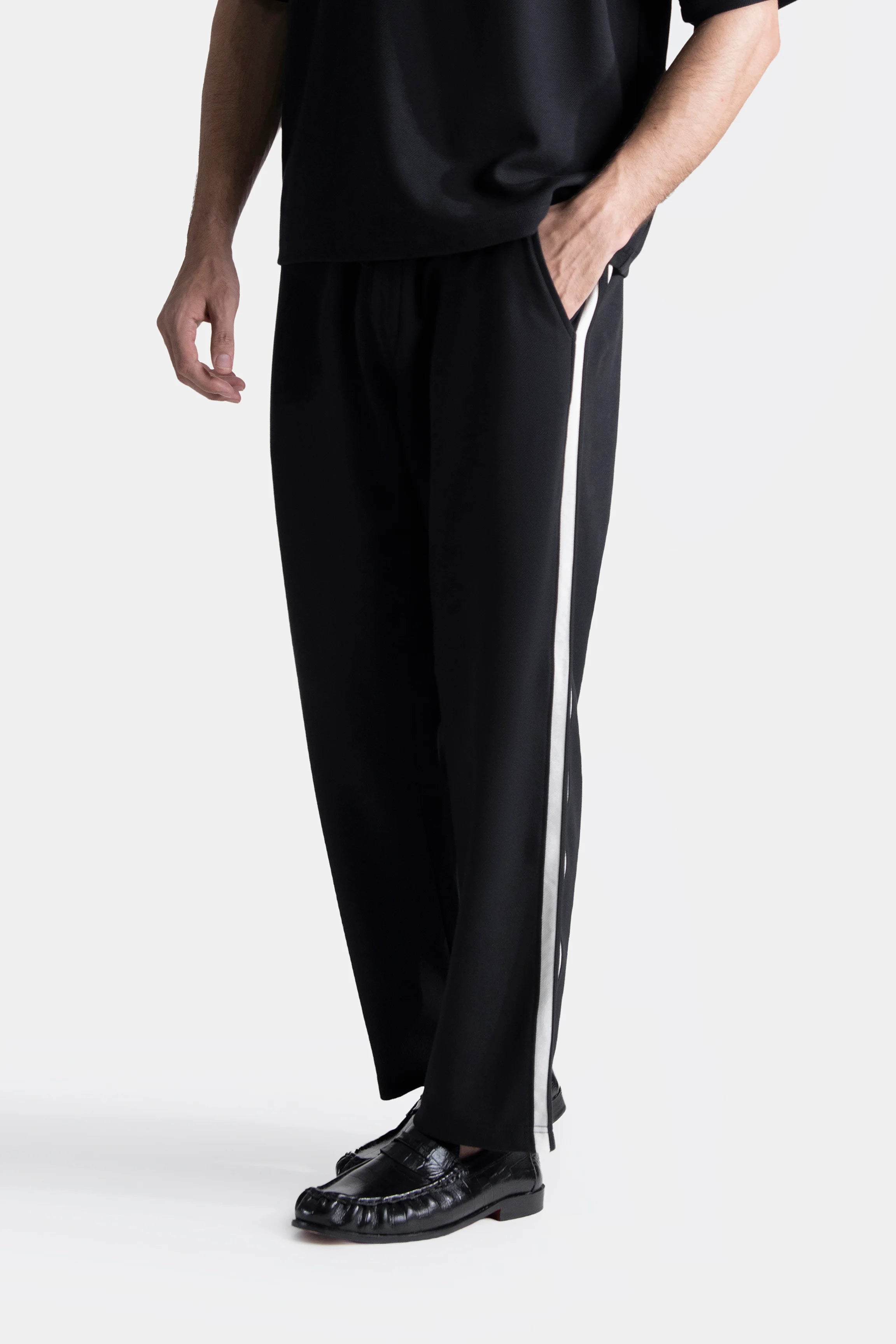 Black loose-fit trousers with contrast side stripe and drawstring waist