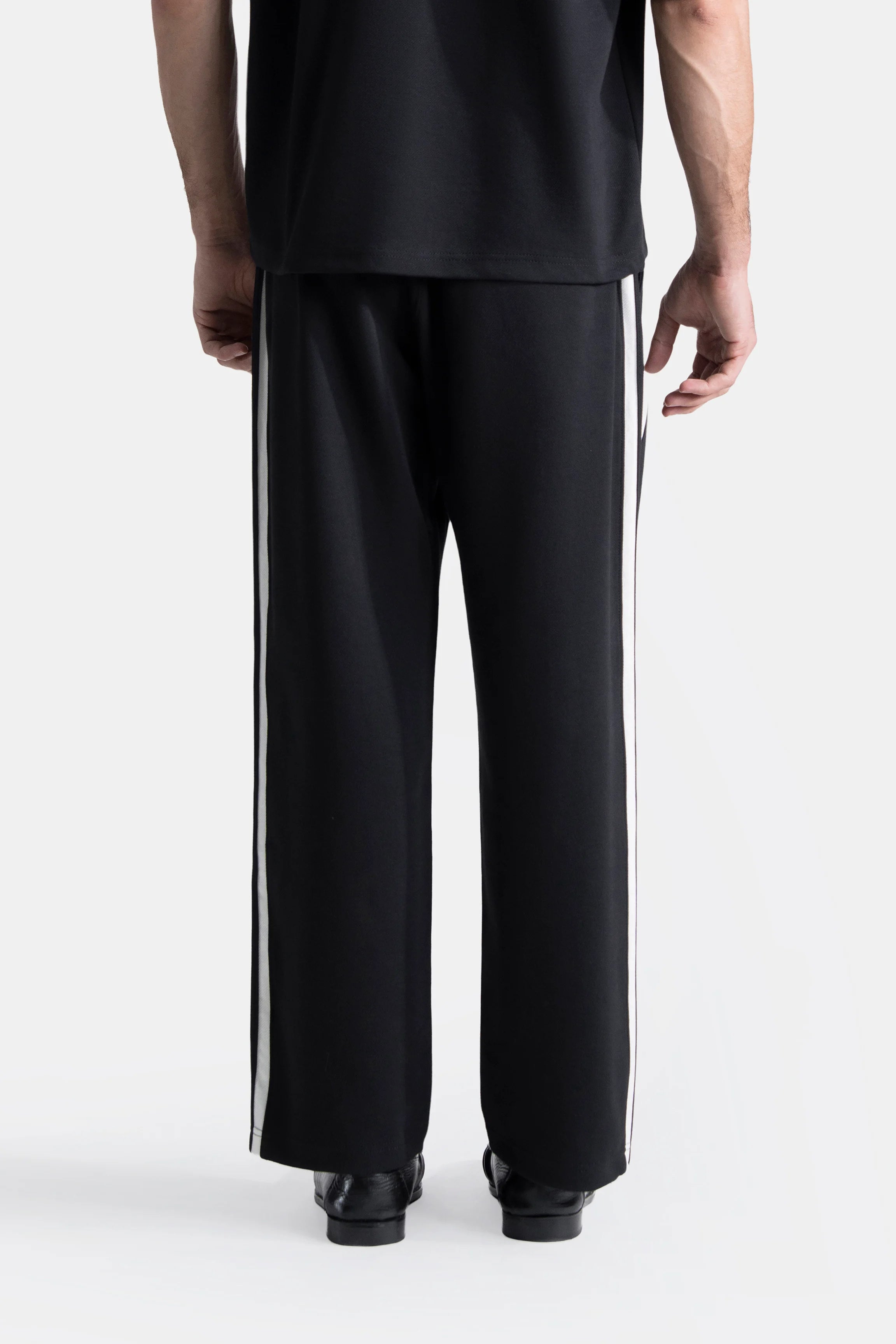 Black loose-fit trousers with contrast side stripe and relaxed straight leg