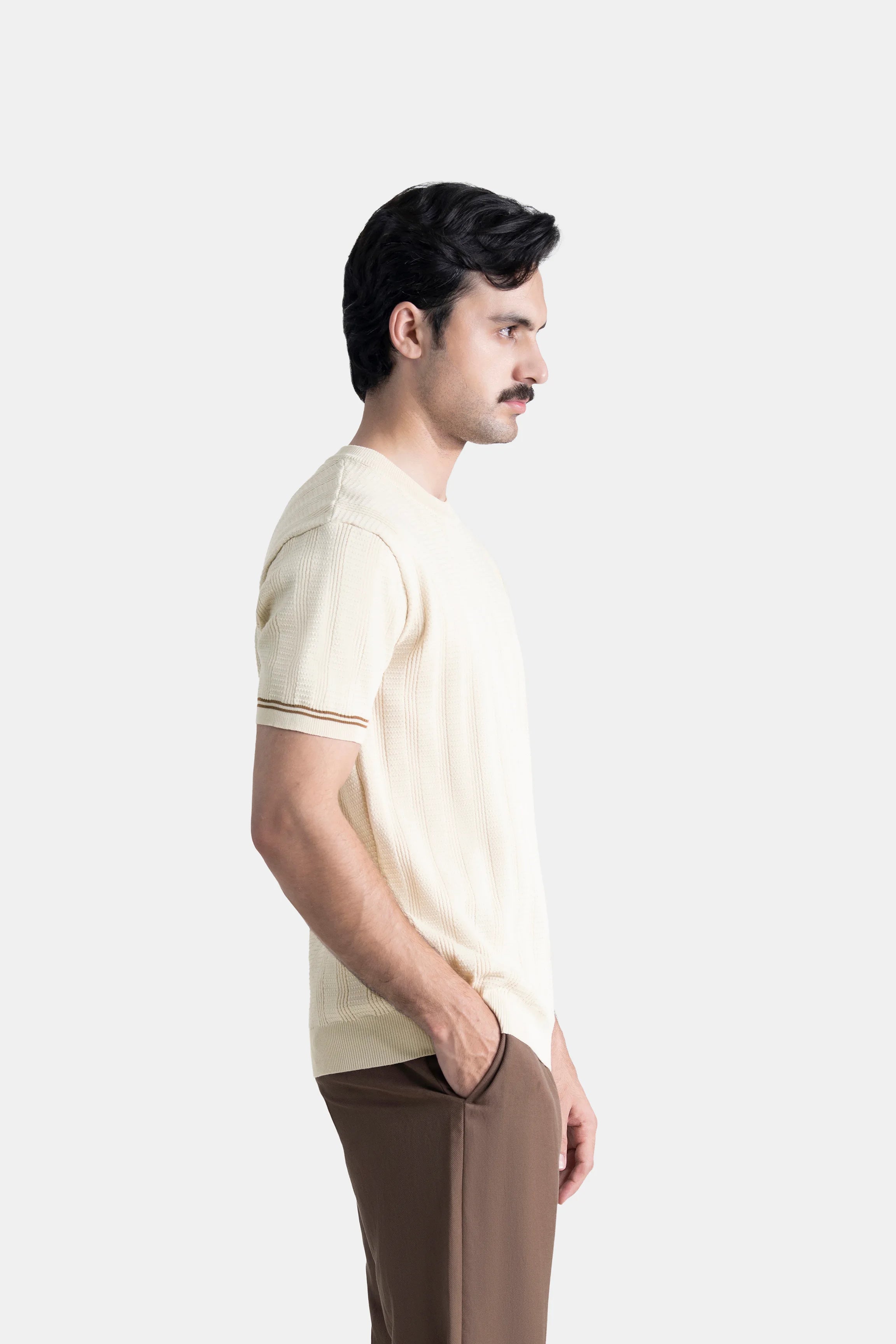 Beige crew neck T-shirt with vertical cable-knit texture; short sleeves, ribbed cuffs.