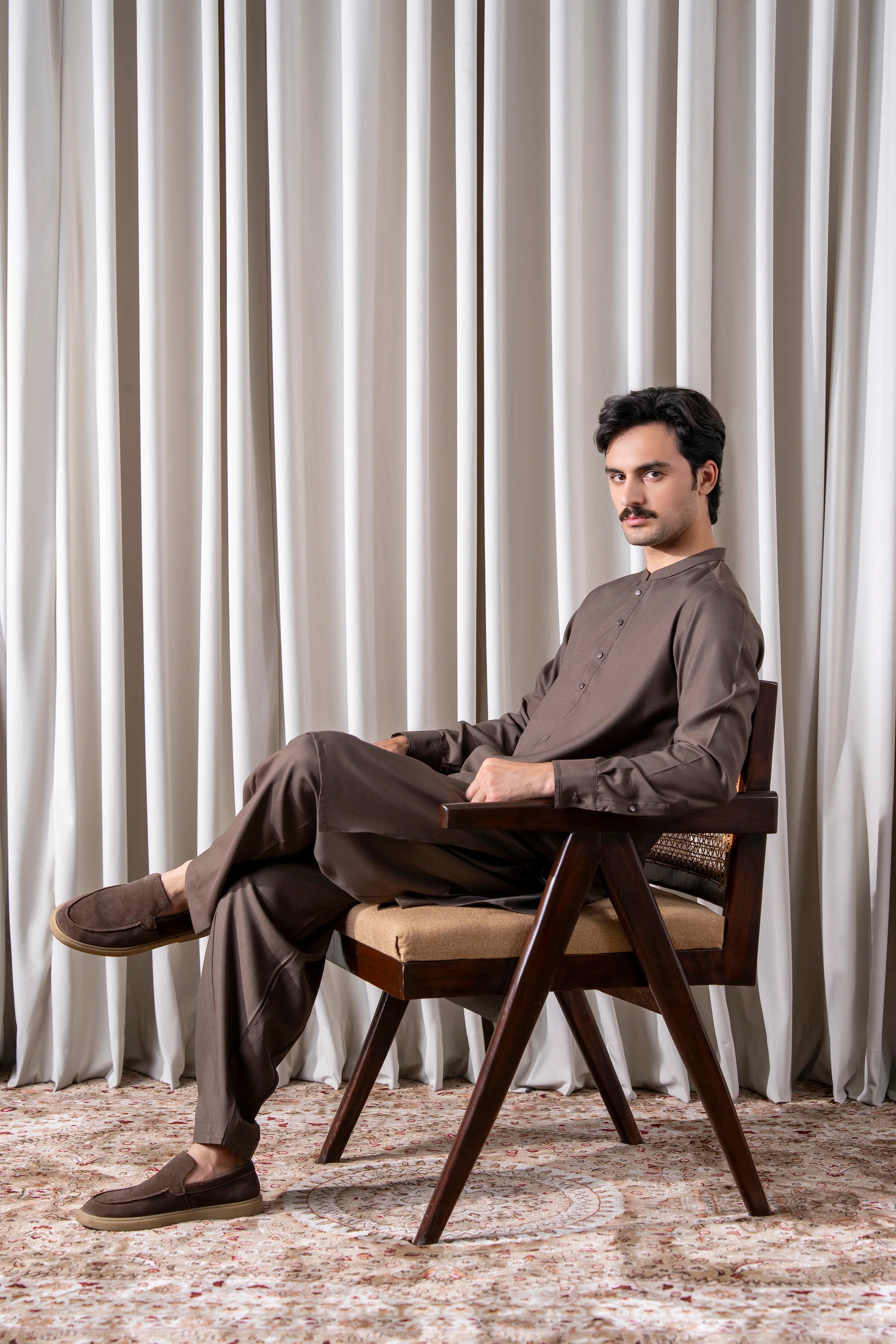 Dark brown textured kameez shalwar set, side view with long kurta and loose shalwar