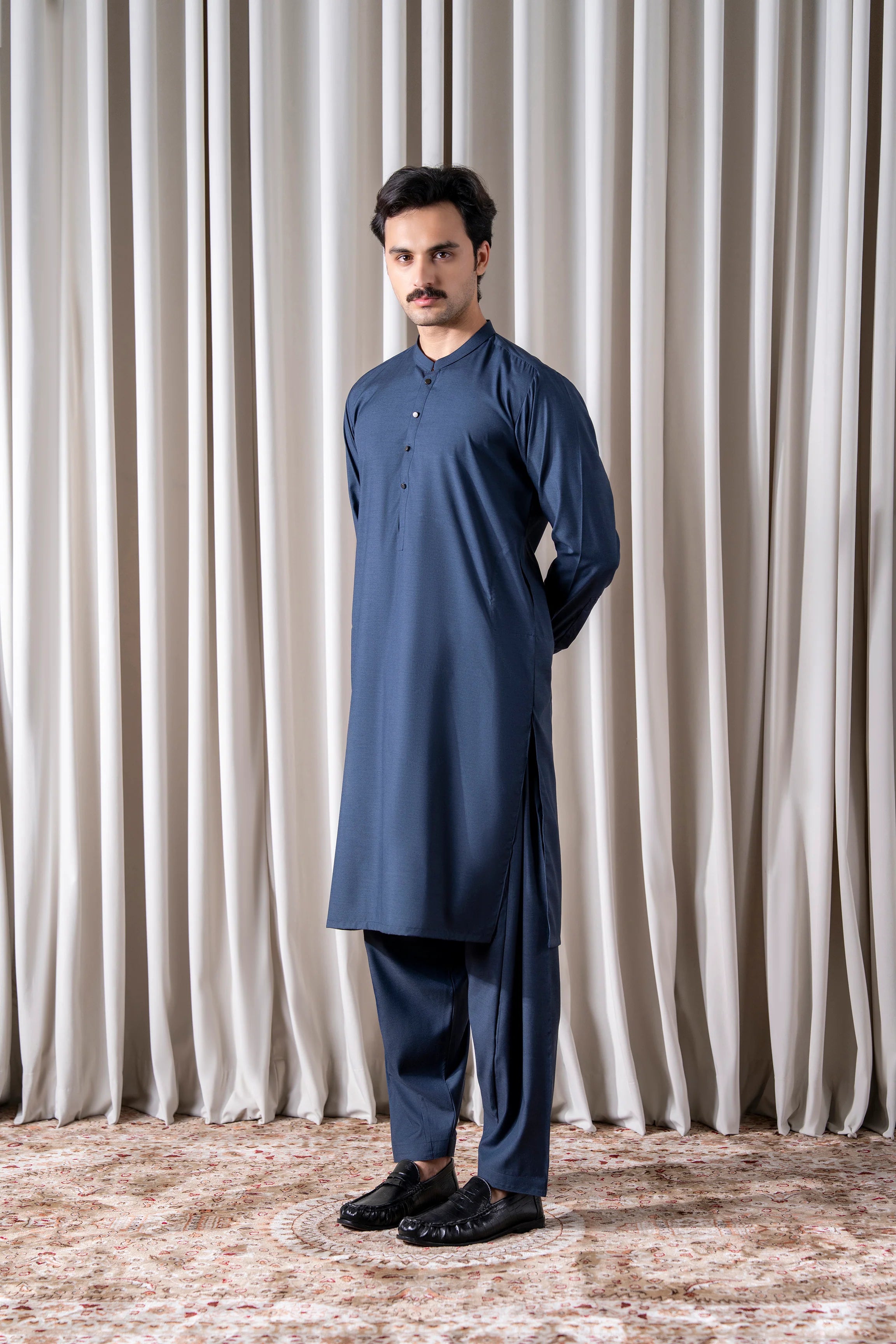 Indigo textured kameez with matching shalwar, standing side view