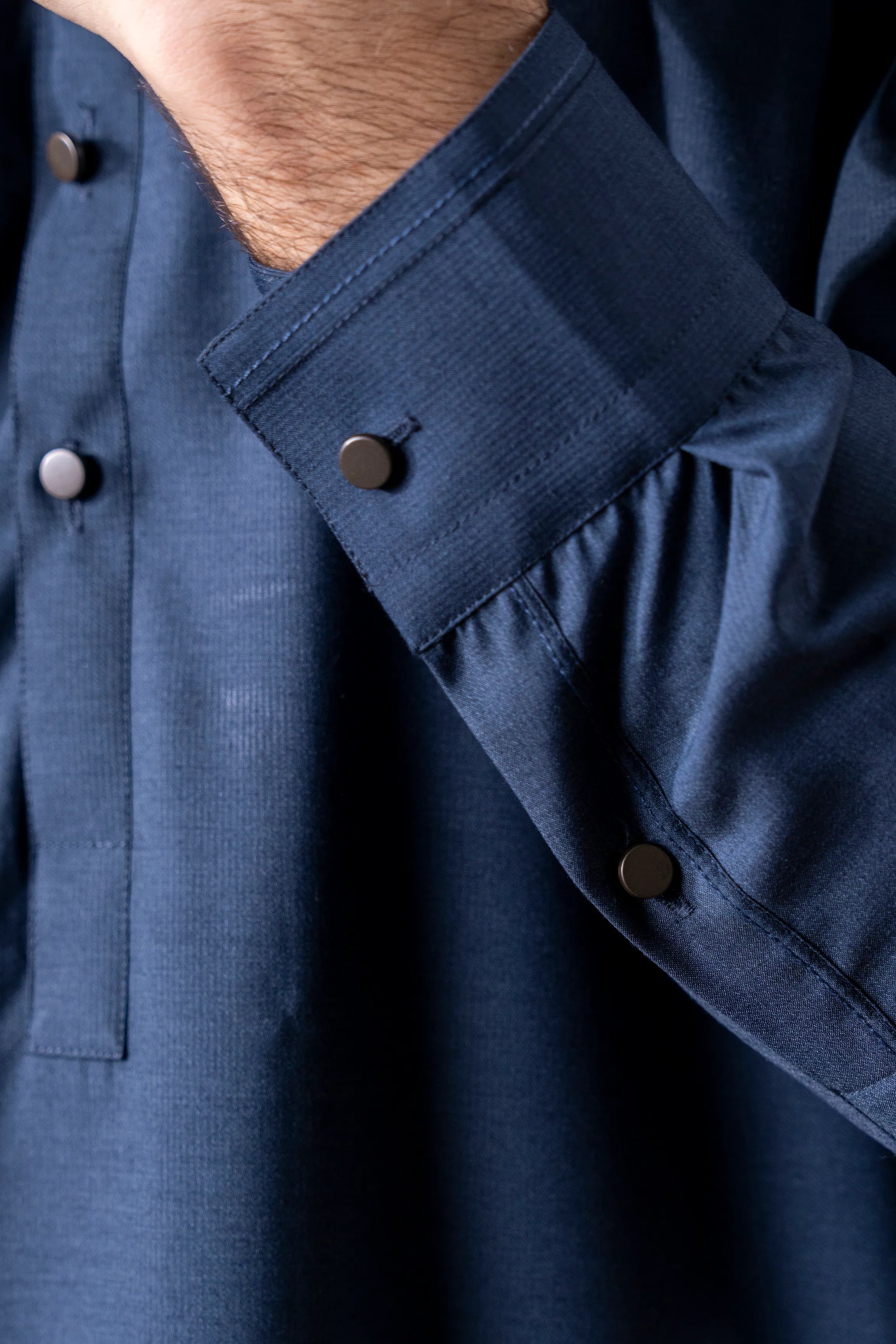 Indigo kameez sleeve cuff with stitched seam and three buttons