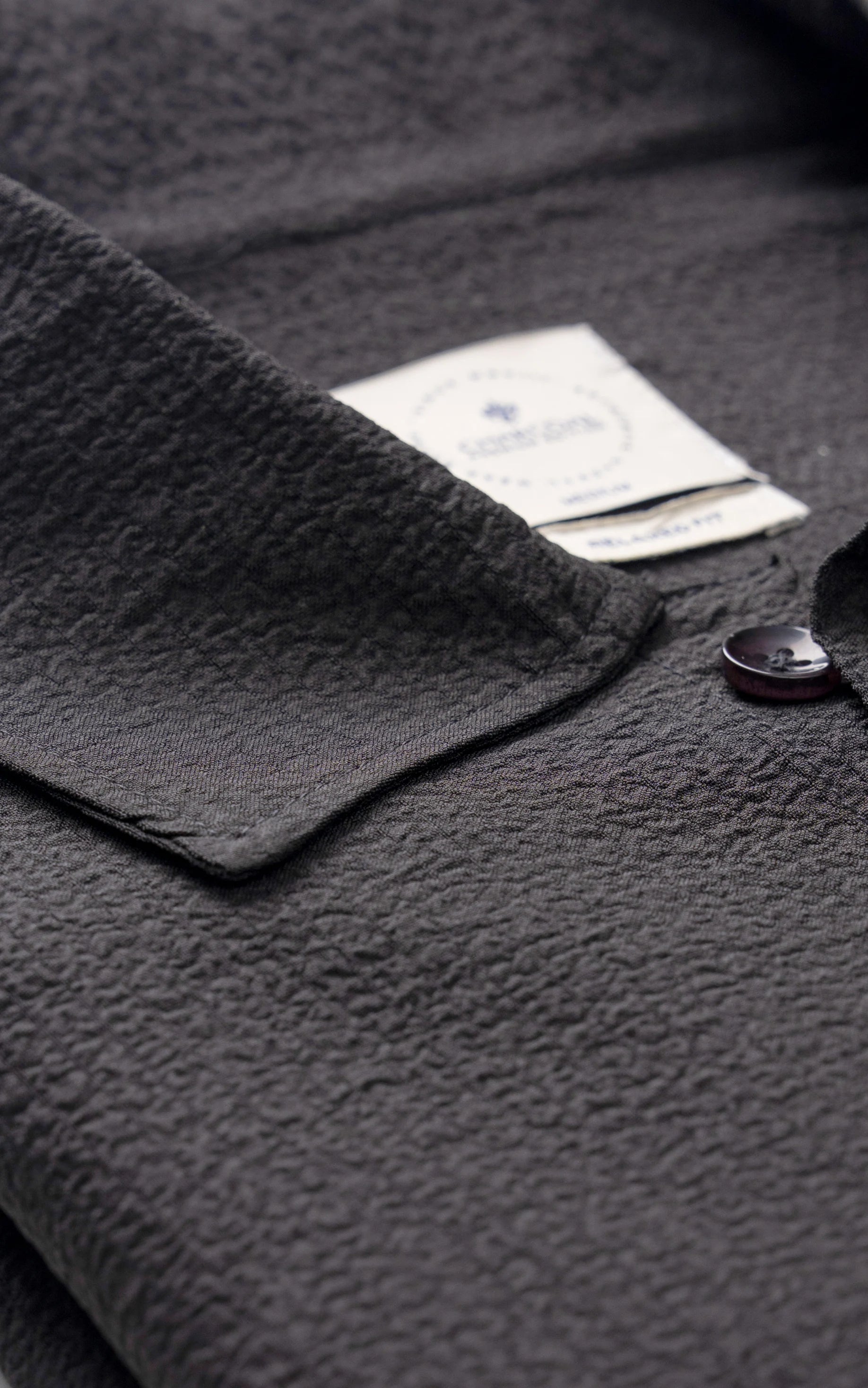 Black relaxed-fit shirt collar and button placket detail