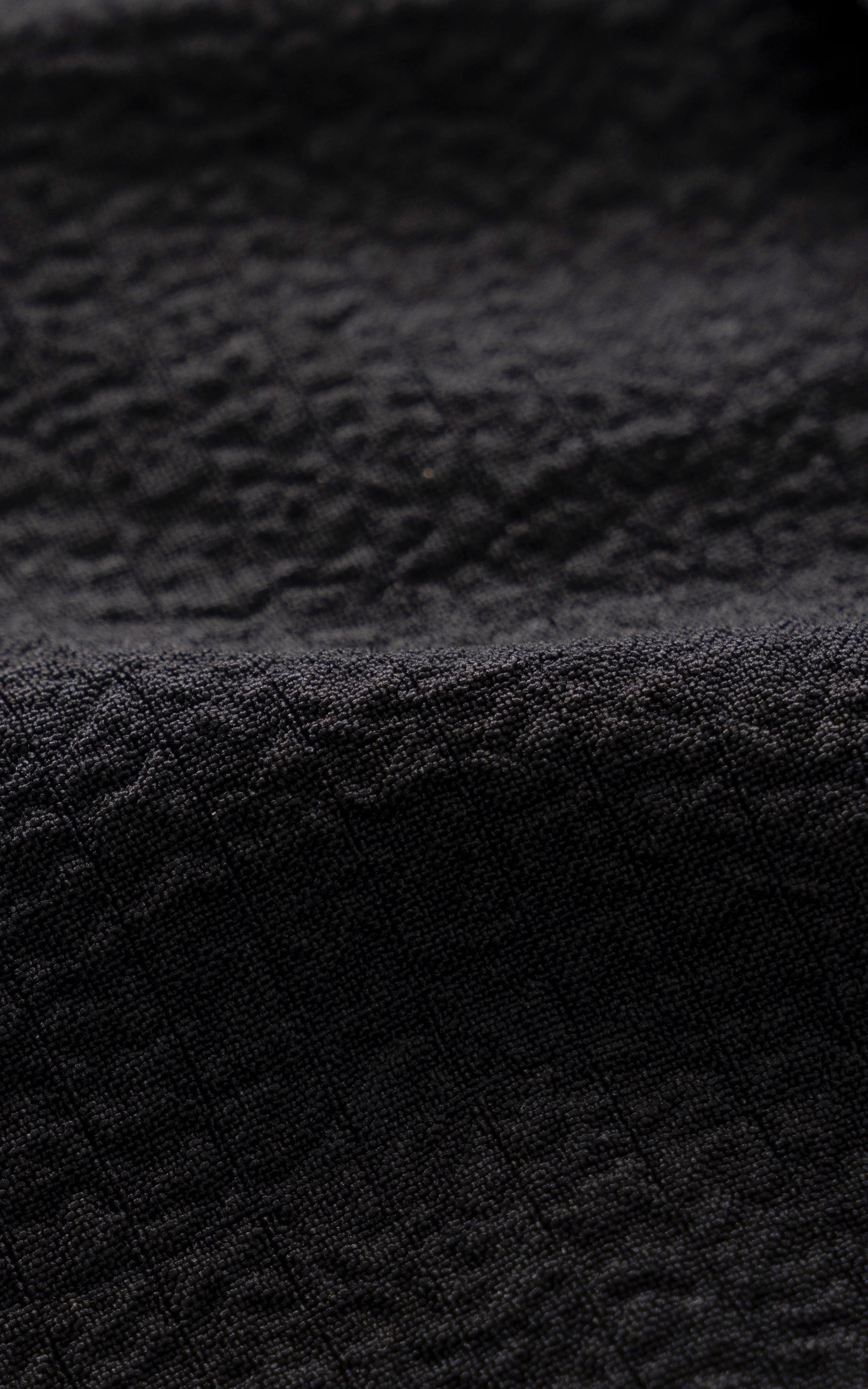 Black relaxed-fit shirt fabric texture close-up