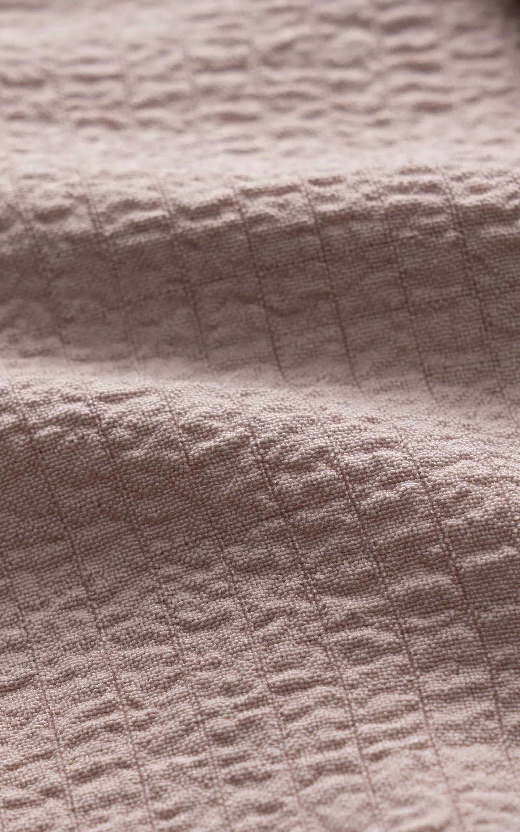 Khaki shirt fabric close-up with subtle woven texture