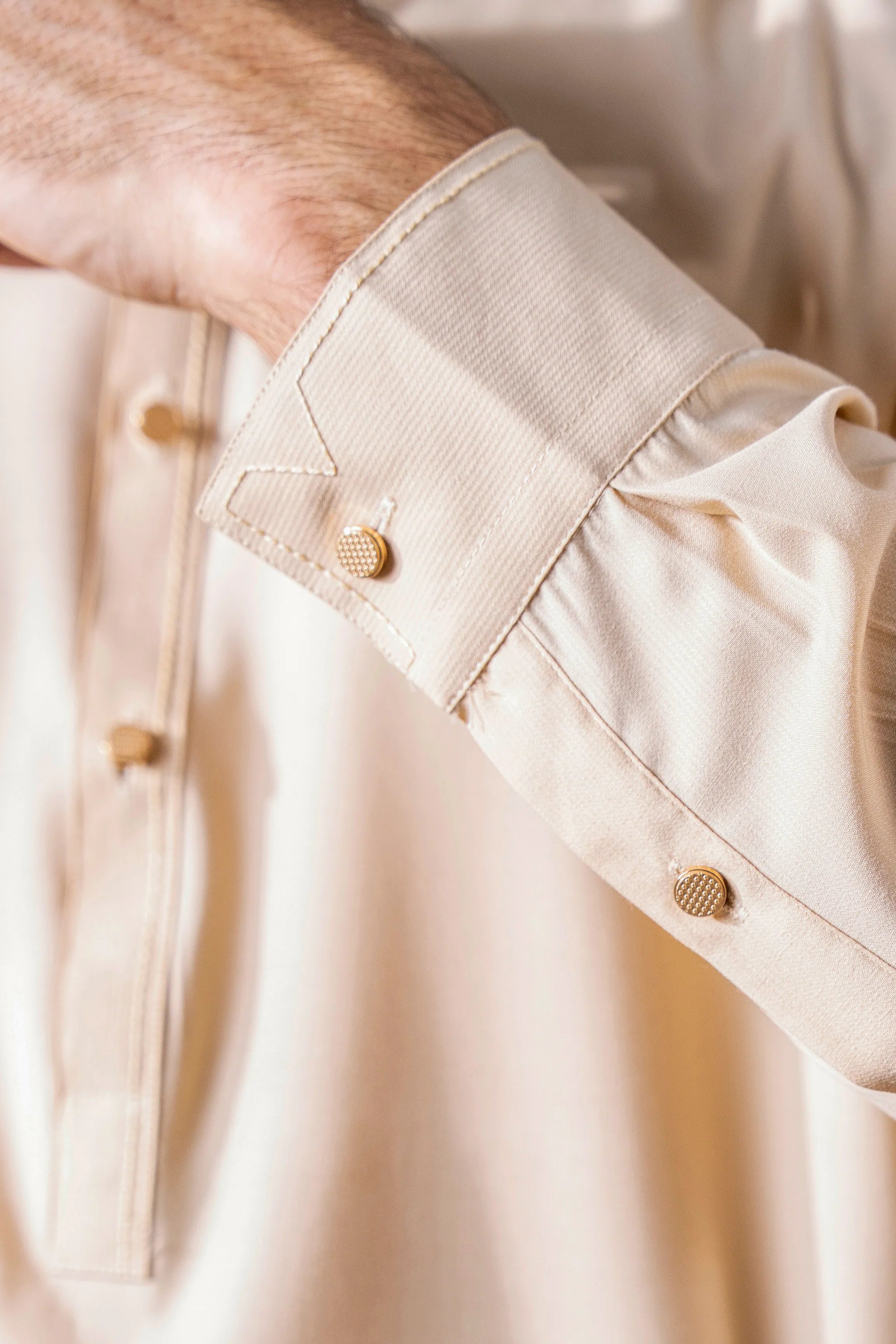 Beige kameez sleeve cuff with stitched placket and button closure