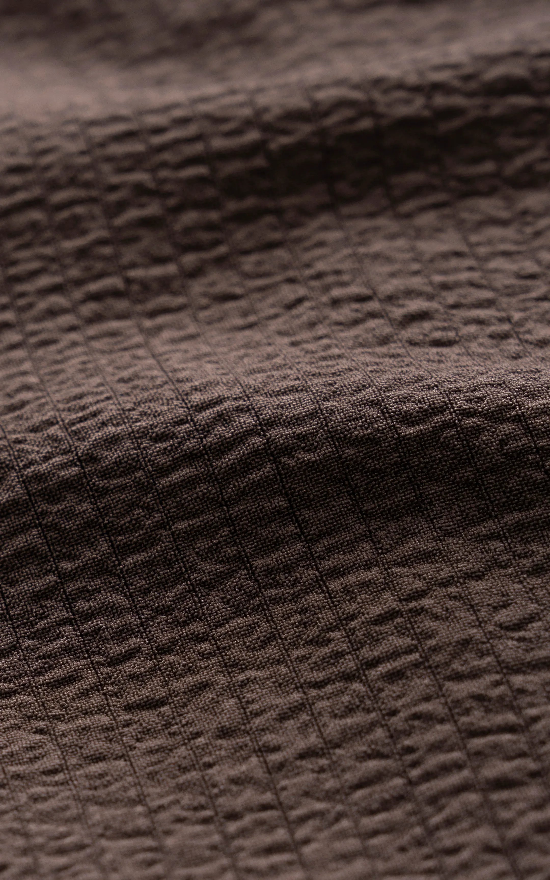 Brown textured woven shirt fabric with subtle grid-like pattern