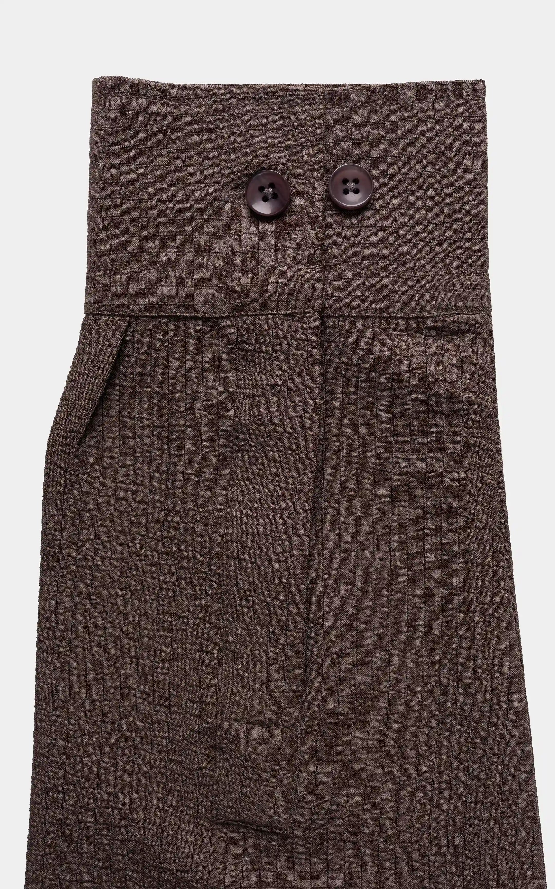 Brown button placket and collar yoke with two dark buttons