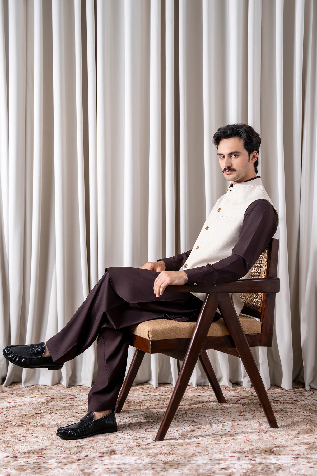 Cream waistcoat with gold-button front and patch pockets, styled with dark trousers