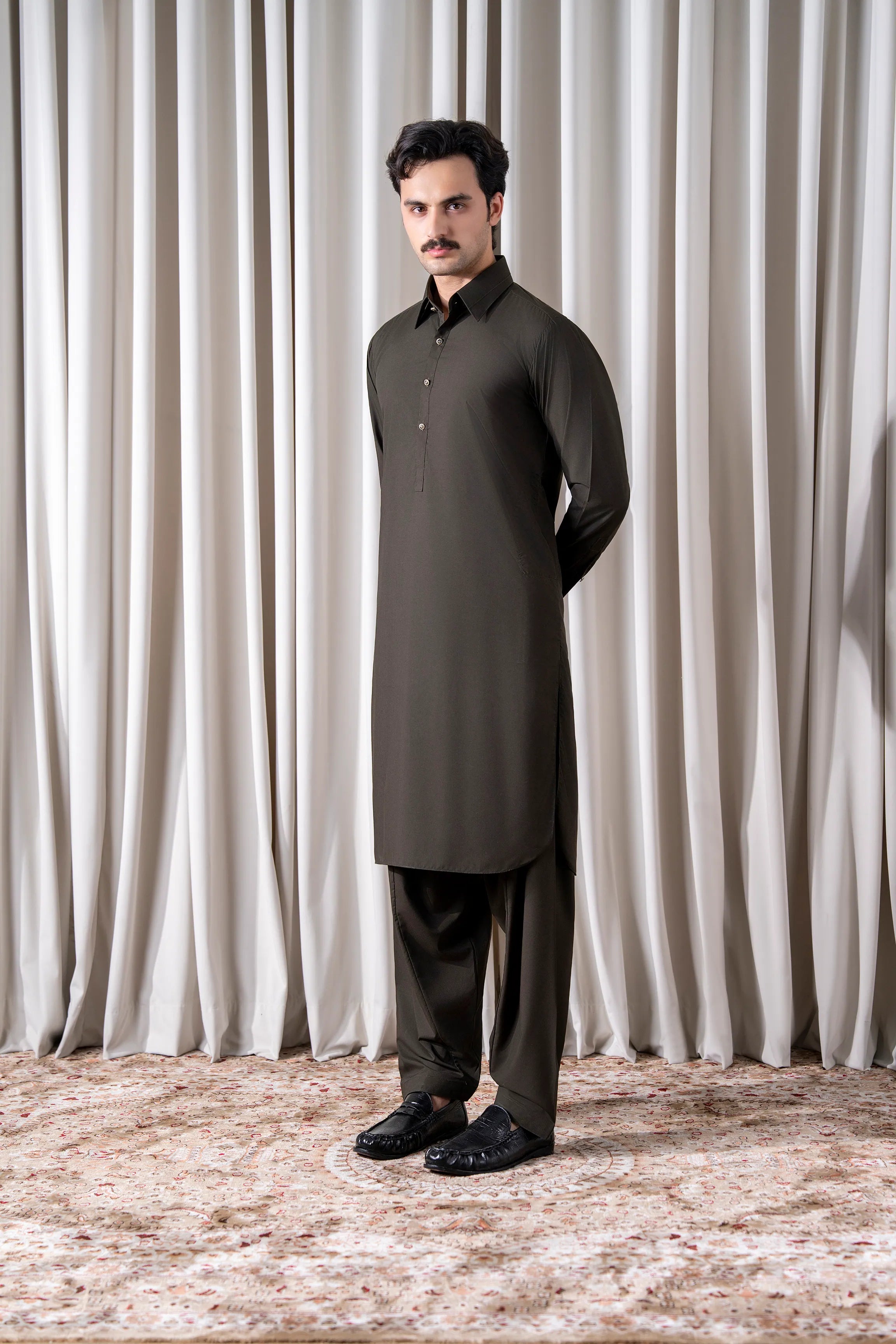 Olive kameez shalwar set with long stand-collar kurta and matching trousers.