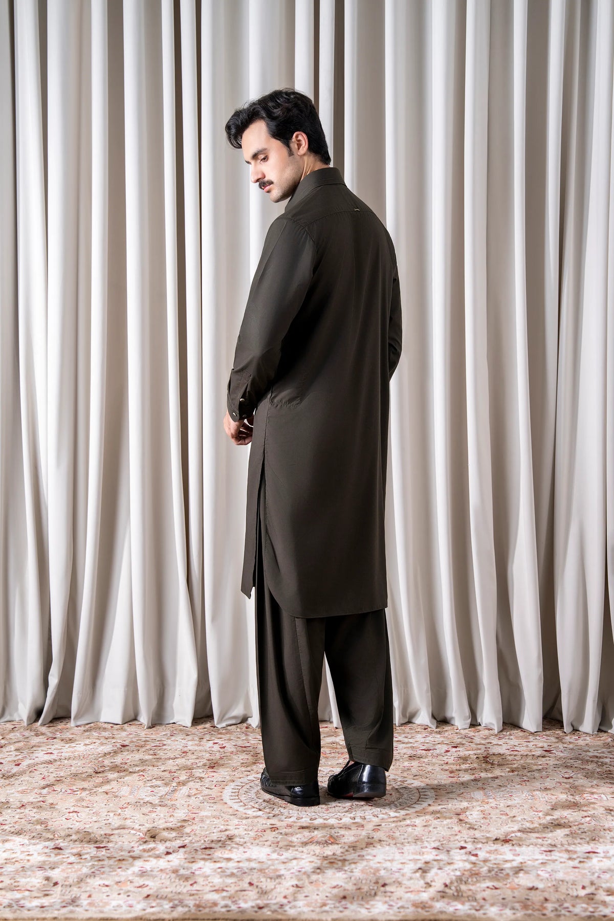 Olive blended kameez shalwar with long kurta and tapered matching pants.