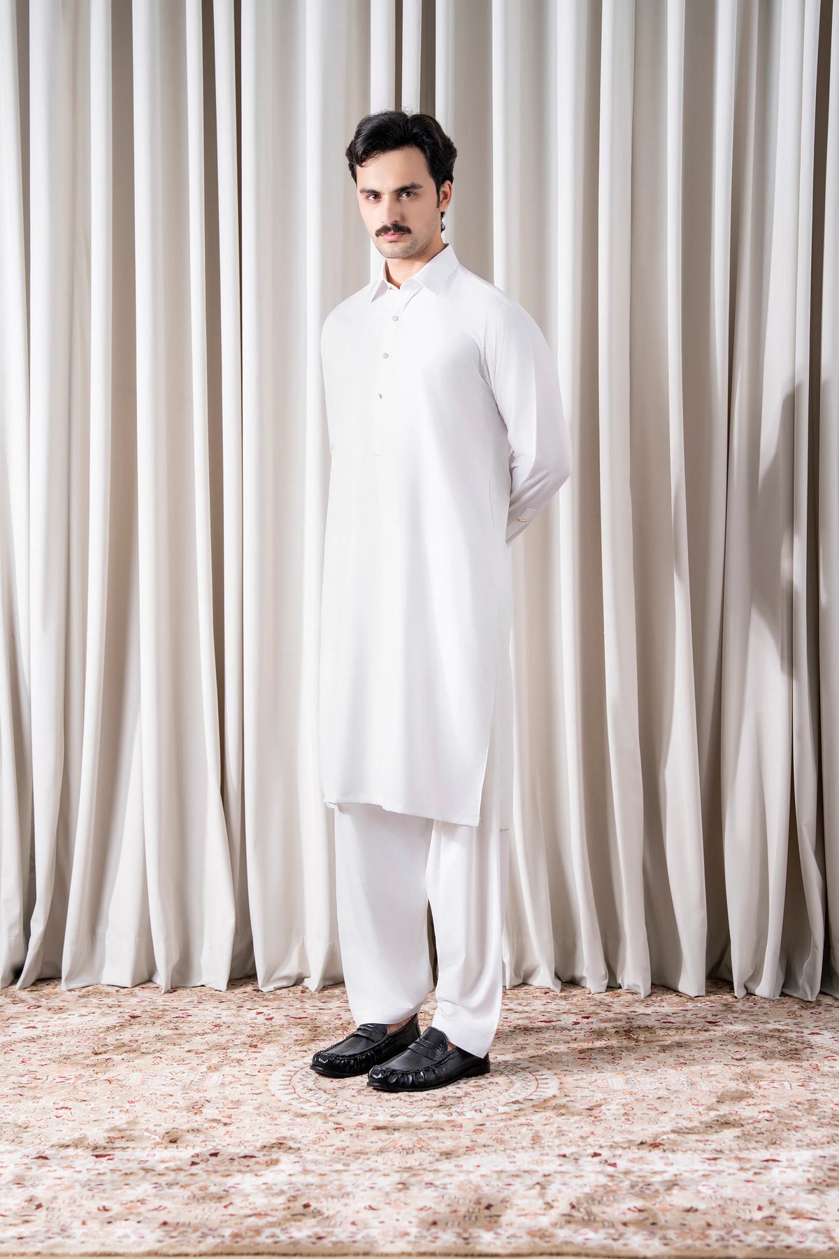 White kameez shalwar set, full-length view of tunic and loose shalwar legs