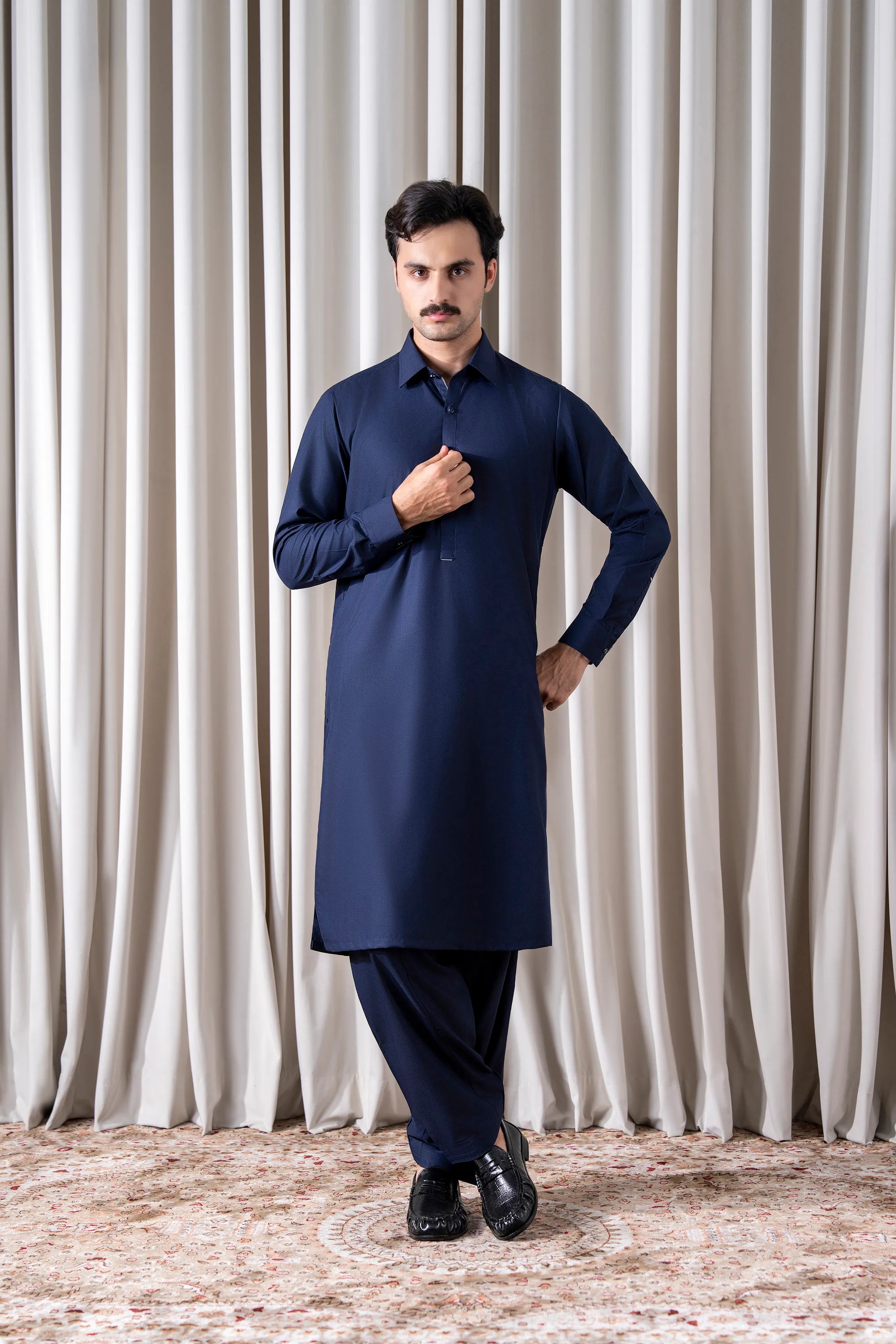 Navy kameez shalwar outfit with long tunic, buttoned collar, and relaxed trousers