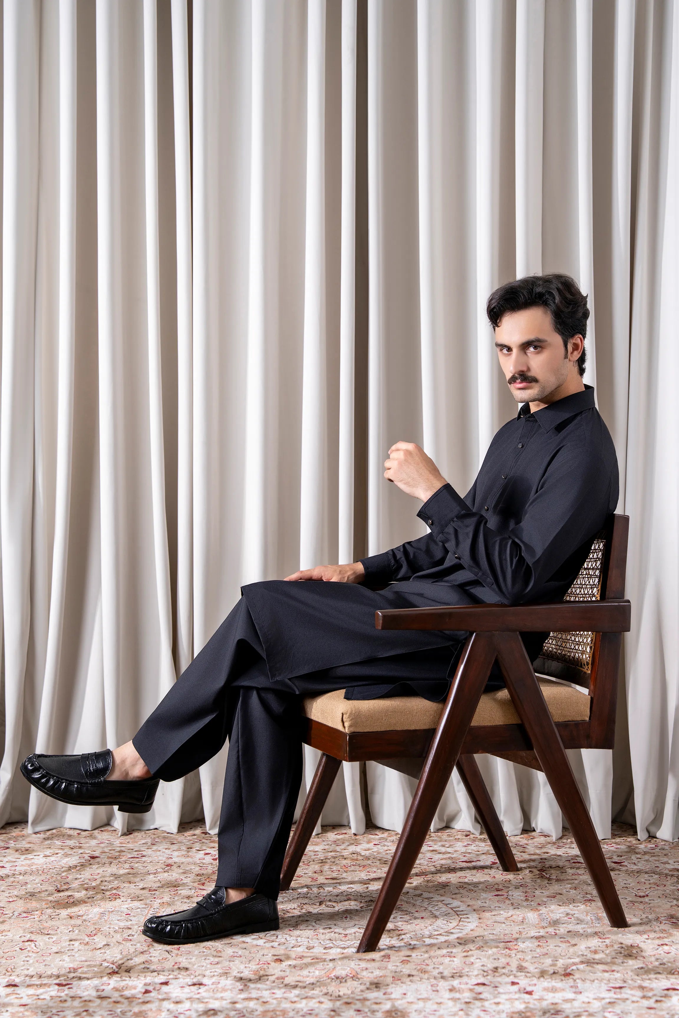 Black textured kameez shalwar set with long kurta and button placket, matching straight shalwar