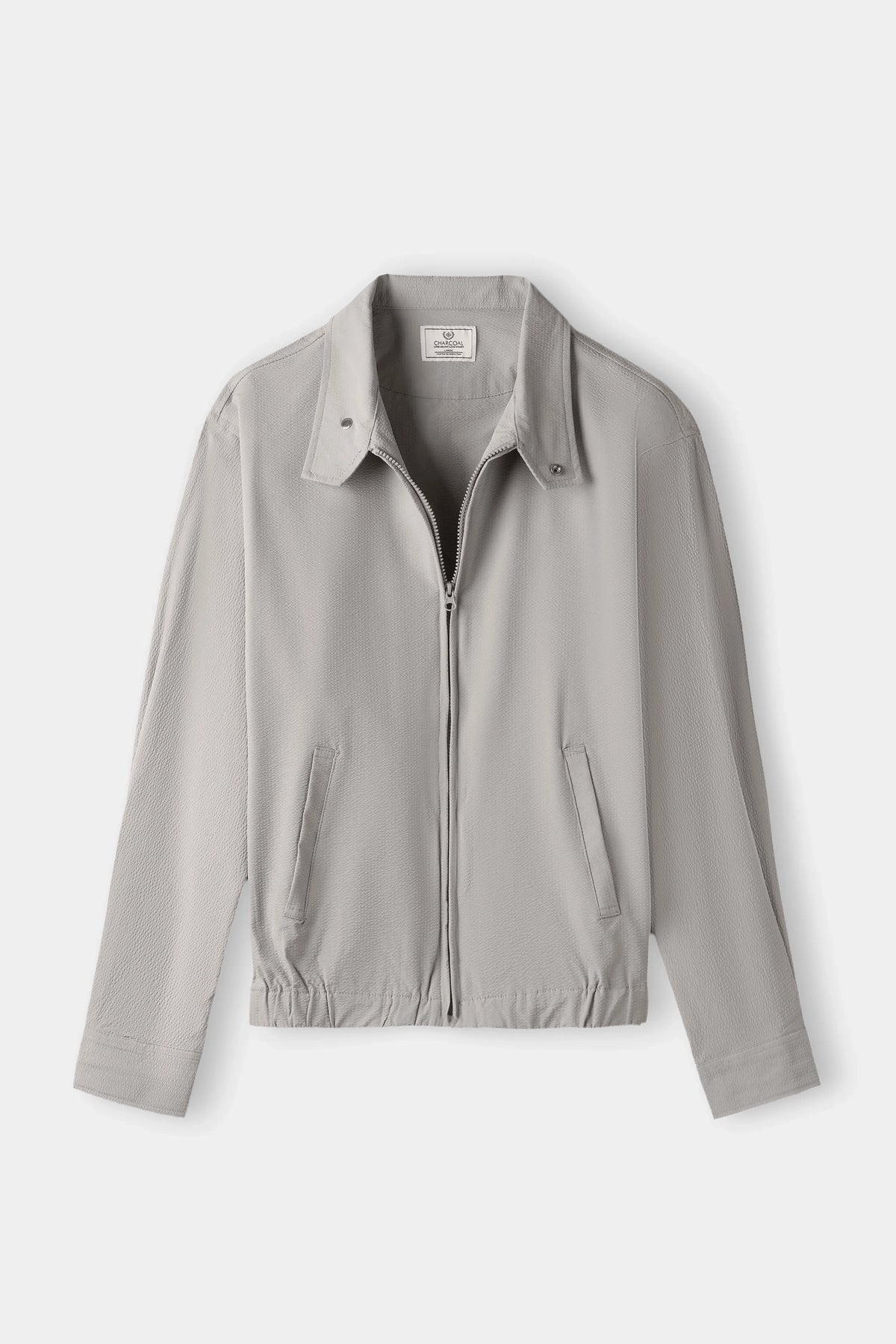 Seersucker jacket with raglan sleeves, front zip, point collar, elastic waist hem.