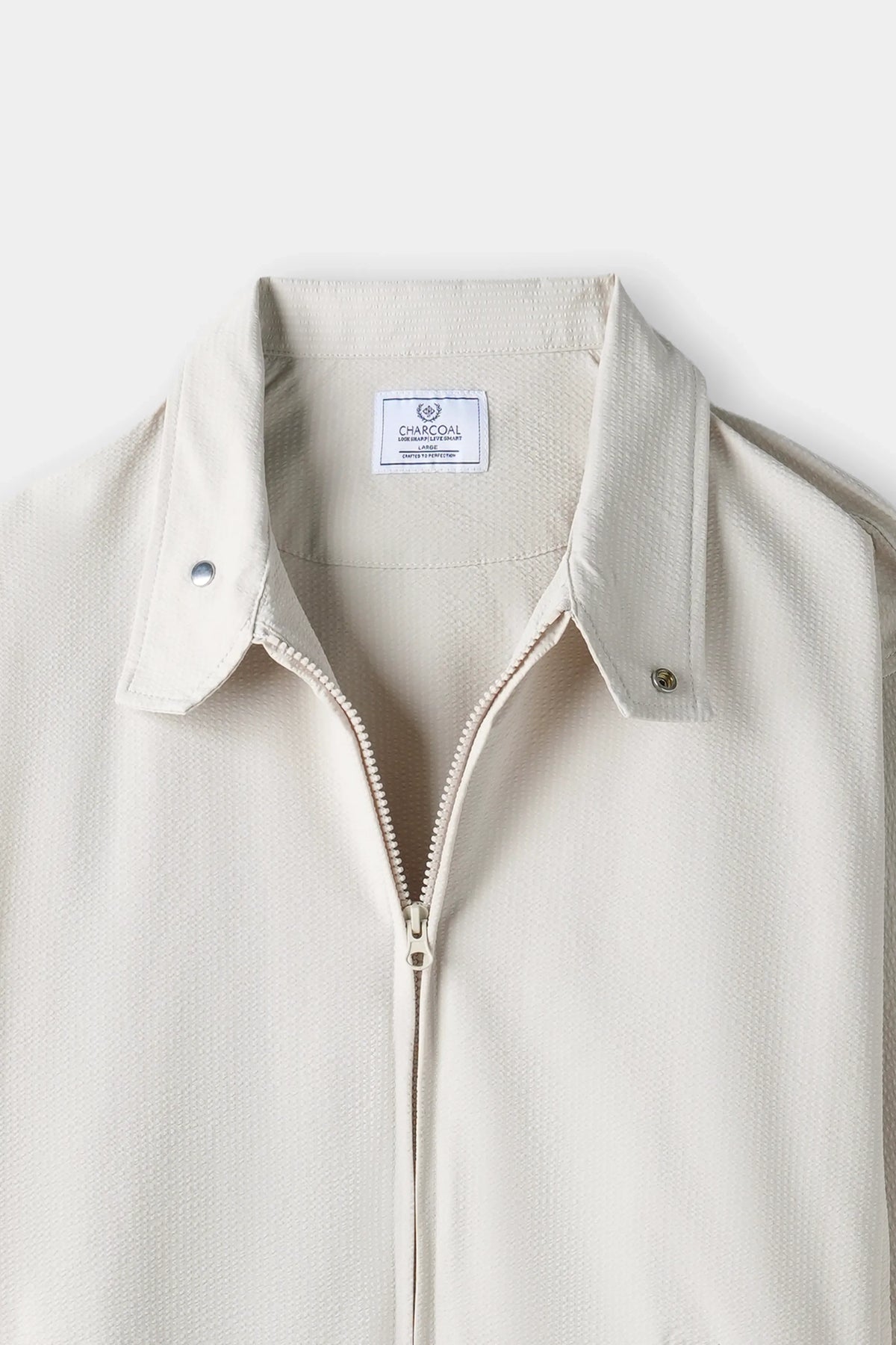 Beige seersucker jacket close-up: spread collar with zipper front