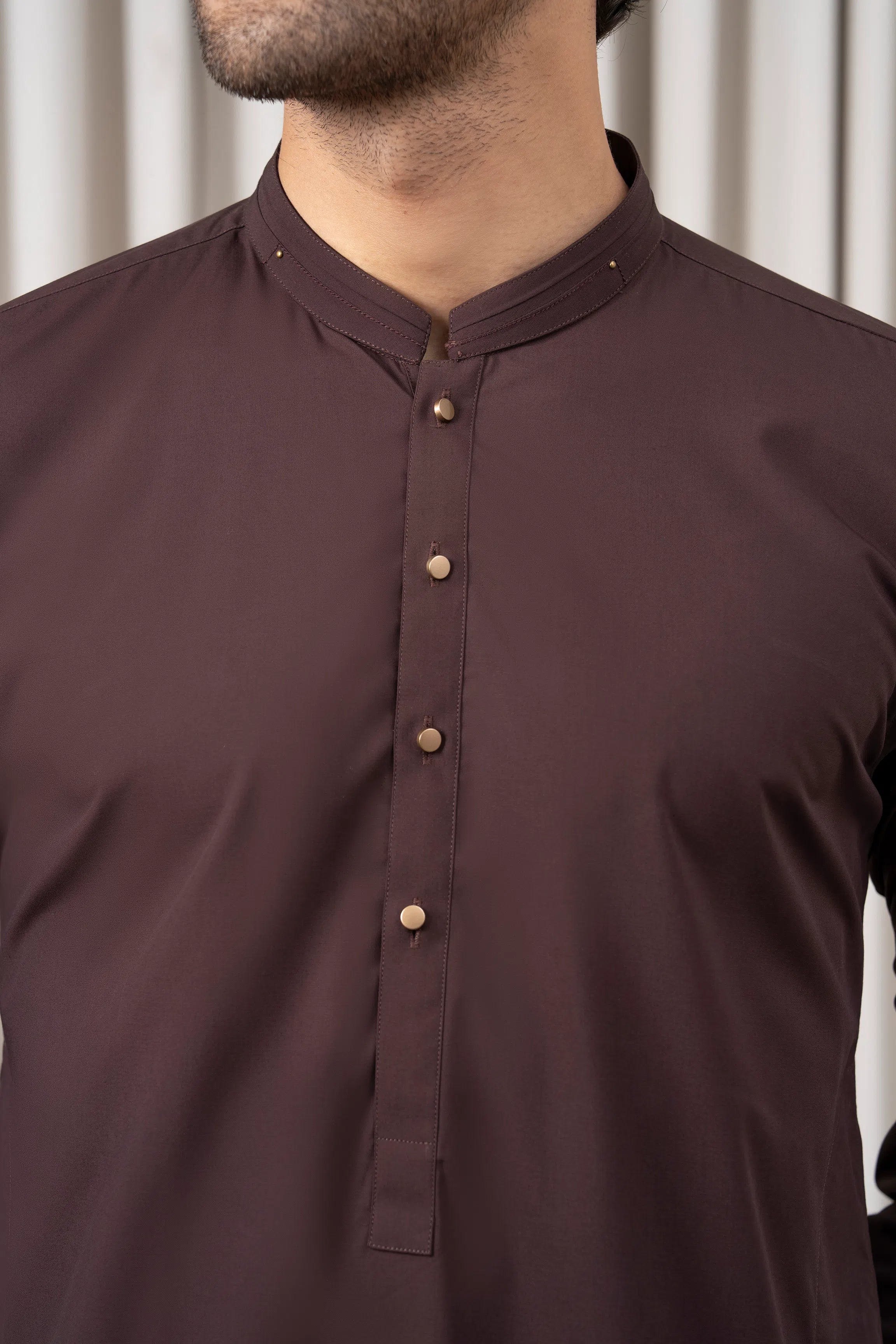 Dark brown kurta neckline with small button placket and collarless design