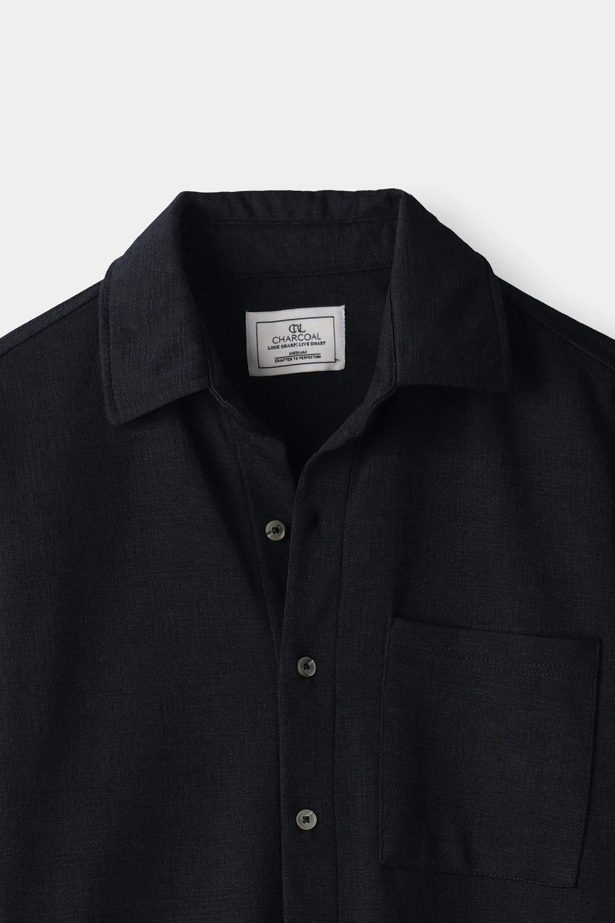 Black self-textured casual shirt with regular collar, button placket, and chest pocket