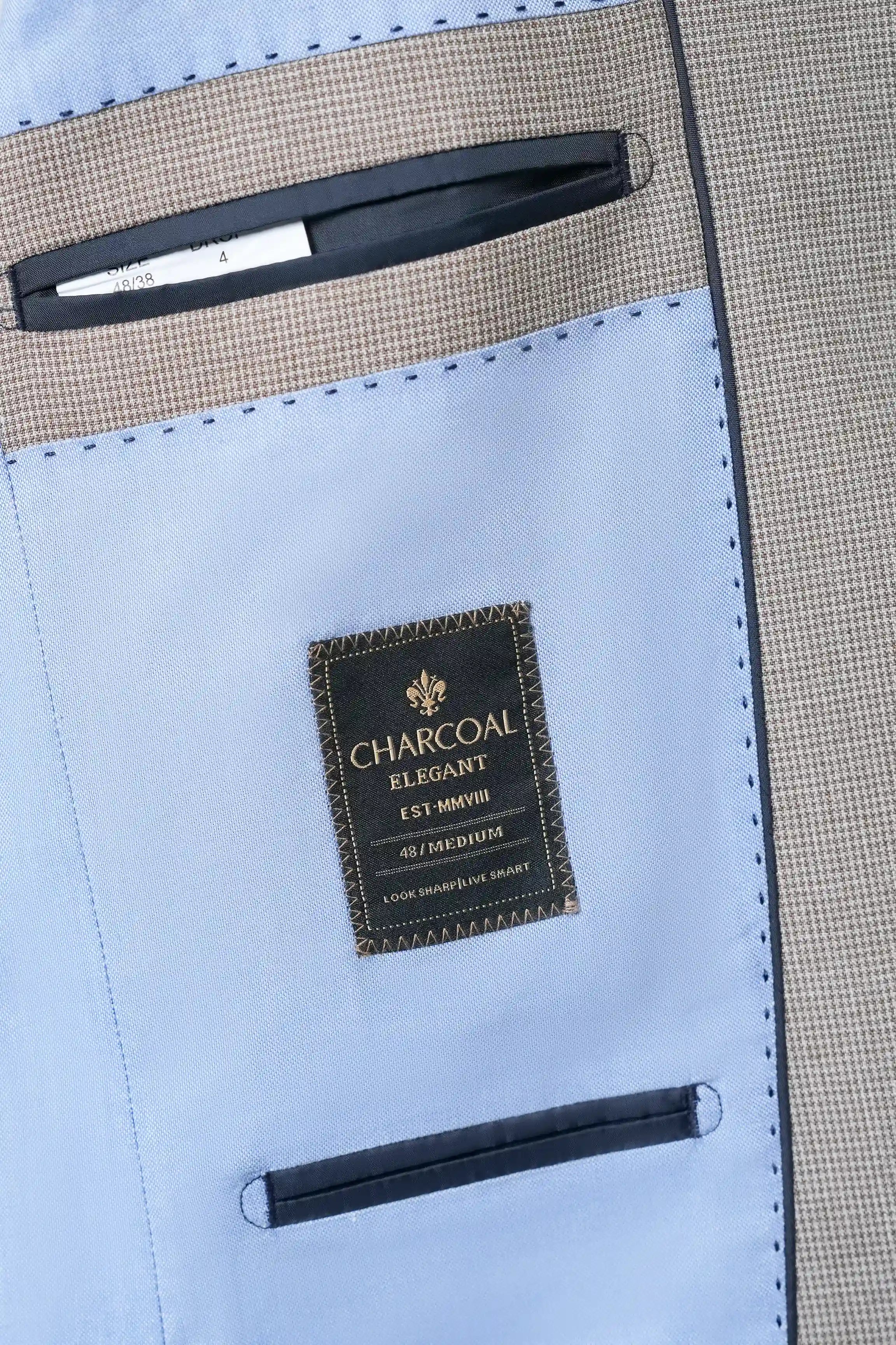 Khaki check coat inner label on light-blue lining with stitched seams