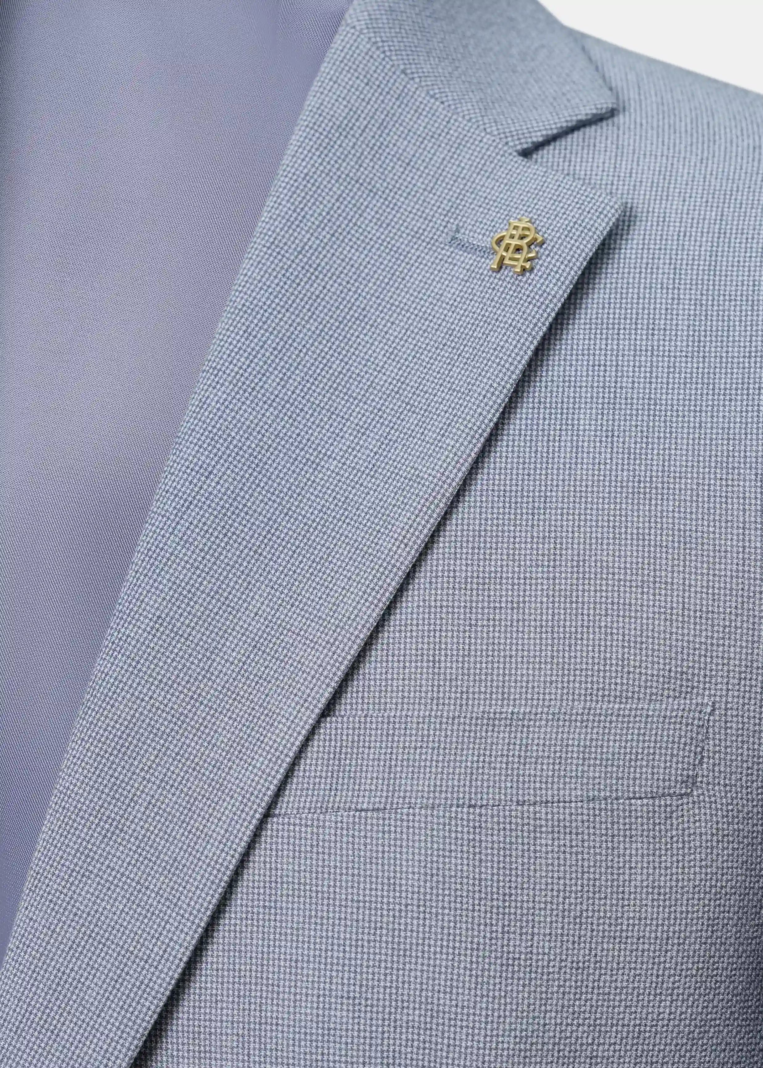 Grey textured casual coat lapel with gold pin and chest pocket