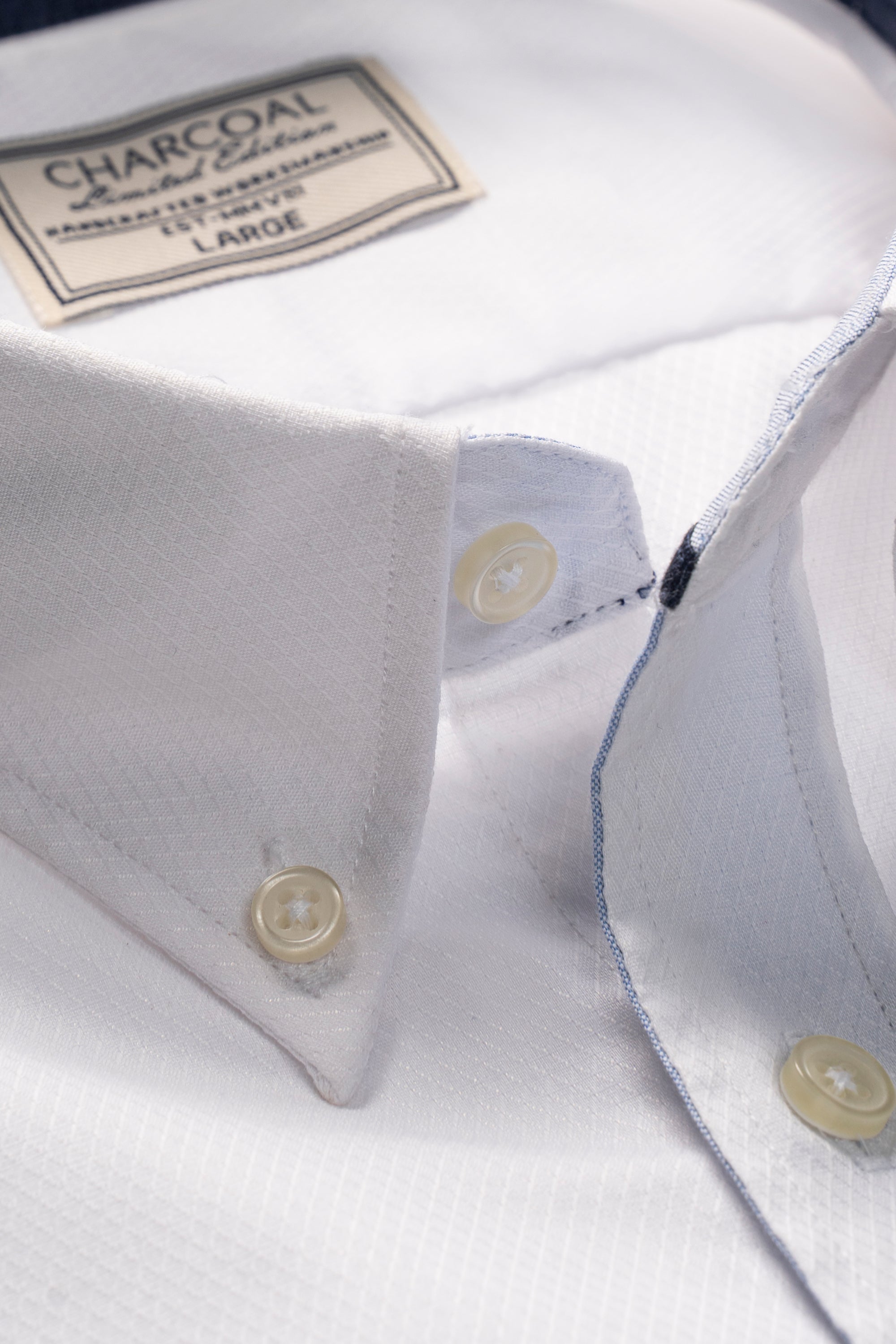 Limited edition shirt neck and placket detail, white fabric, gold buttons, blue edge