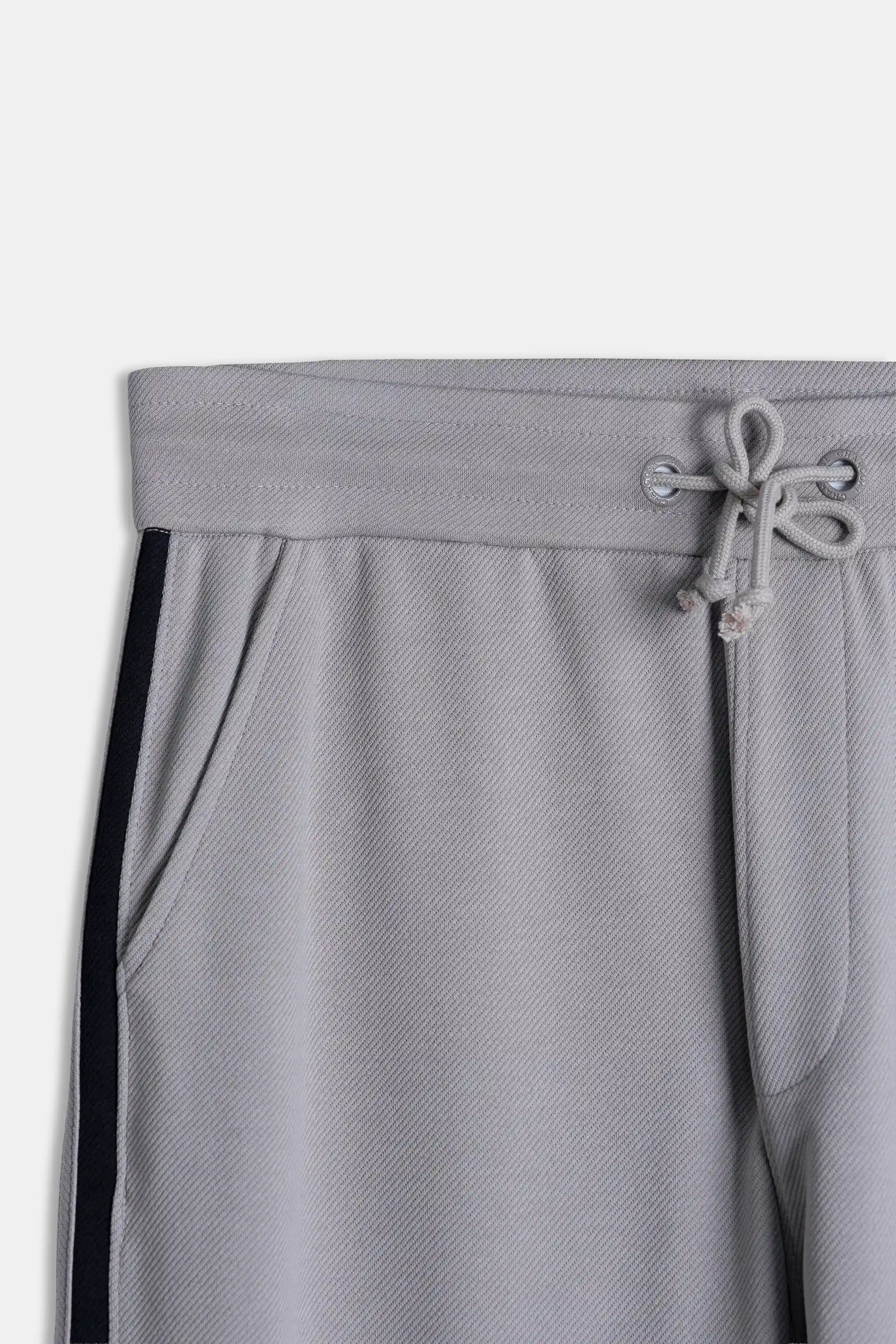 Grey elastic waistband with drawstring and metal eyelets, navy side panel