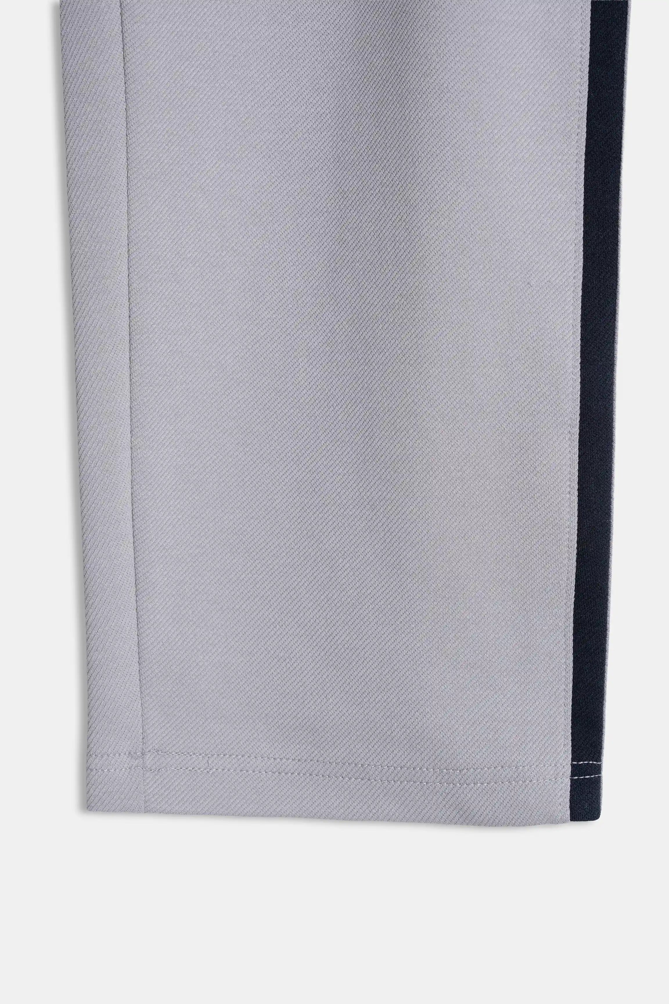 Grey trouser fabric with navy side stripe and stitched hem detail
