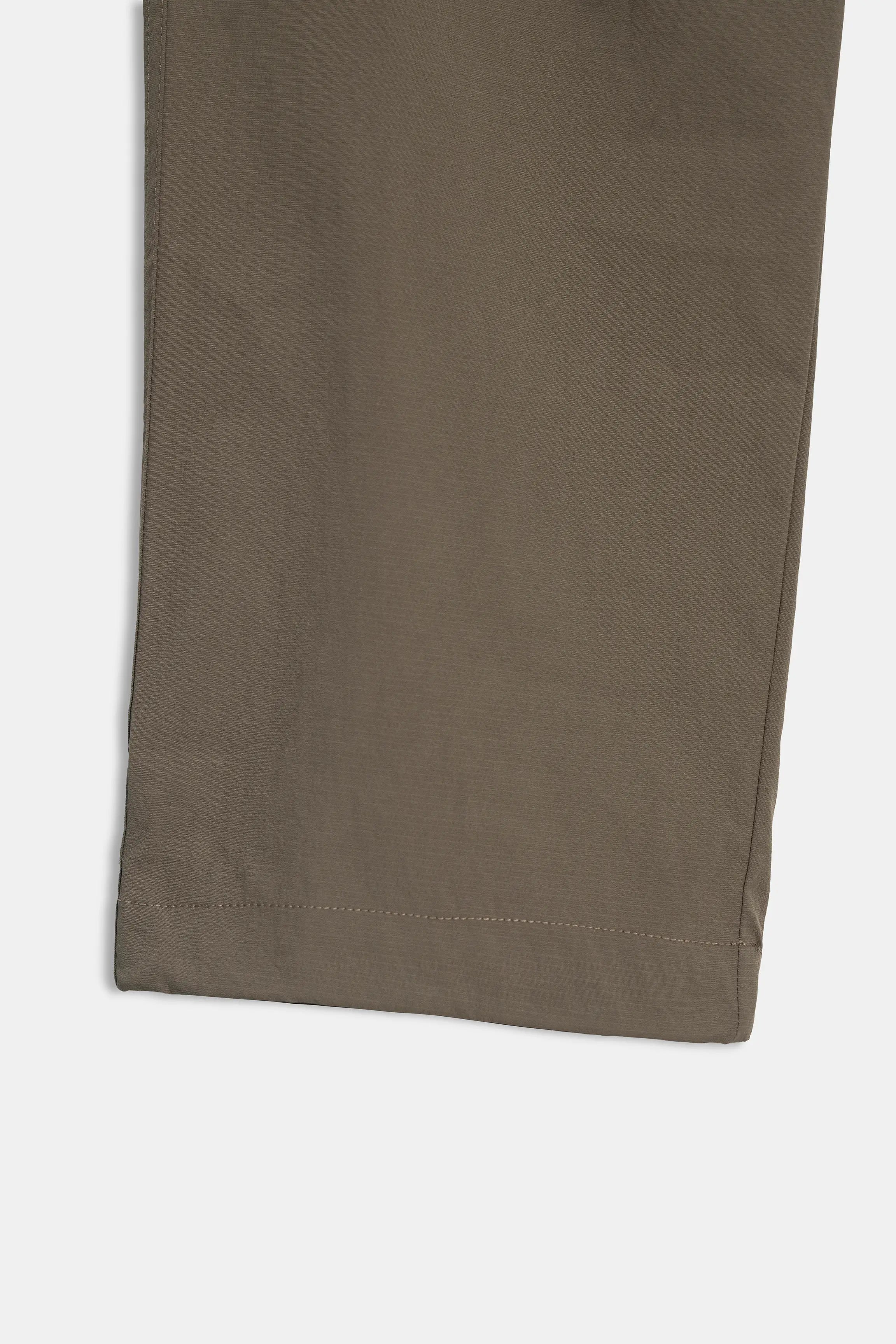 Olive casual trousers fabric close-up with straight seam and hem finish